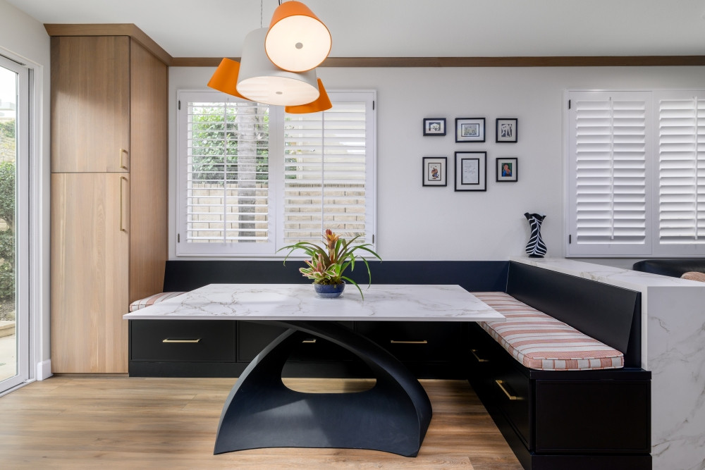 A charming breakfast nook designed for both style and function! The built-in storage bench, perfectly matching the kitchen island, is topped with a pop of orange in the cushion and chandelier for a warm, inviting touch. Paired with a stunning white oak pantry. 

#KitchenDesign #KitchenRemodel #BreakfastNook #InteriorDesign #CustomCabinetry #BuiltInSeating #LuxuryKitchen #StorageSolutions #HomeDecor #WhiteOakCabinetry #ModernKitchen #CozySpaces #TimelessInteriors #DesignDetails #KitchenGoals #DiningNook #HomeInspo #StatementLighting 
 

 #LTKHome
