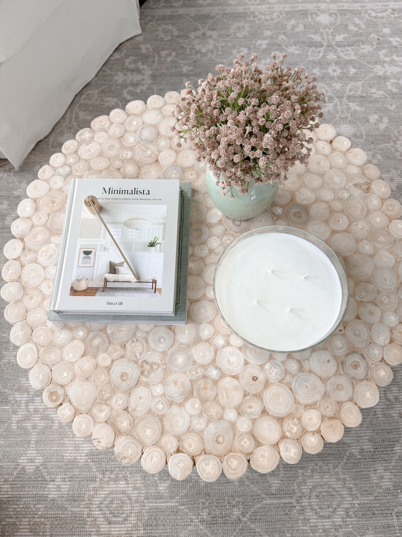 Coffee table. Coastal vibe. Decorative book. Candle snuffer. Faux baby’s breath. Area rug. Sunroom decor  

#LTKHome