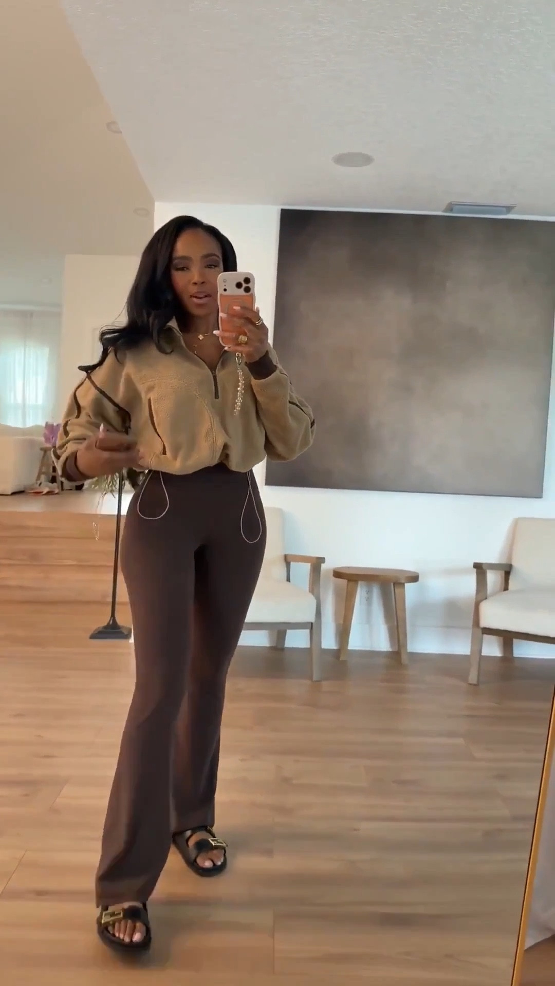 Scroll to shop this cozy neutral outfit featuring a relaxed half-zip pullover styled with chocolate brown flared leggings and casual slides for an effortless everyday look. Neutral tones like this are trending for spring outfits 2026 and make the perfect elevated athleisure outfit, while staple pieces like these can be styled multiple ways so the cost per wear keeps dropping.

Perfect for running errands, travel days, coffee runs, or relaxed weekend outfits.

5'4" | 138 lbs | 34D bust | 27" waist | 40" hips