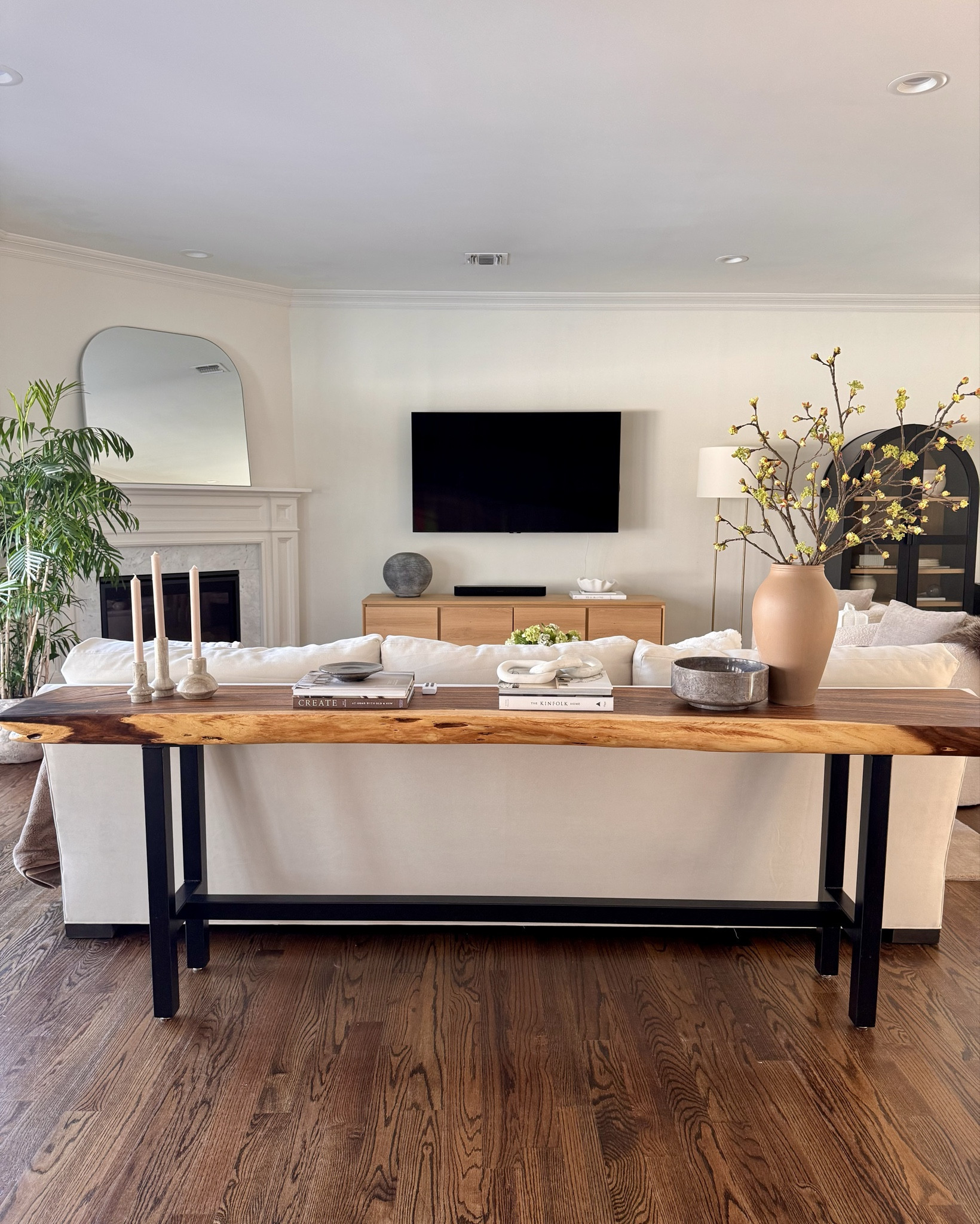 Modern organic living room details I’m loving lately. Warm wood tones, soft neutrals, and simple styling that makes an L-shaped space feel cohesive.

#livingroom #console #sofa #fauxflorals #archcabinet #fireplace

#LTKHome #LTKSeasonal #LTKSaleAlert