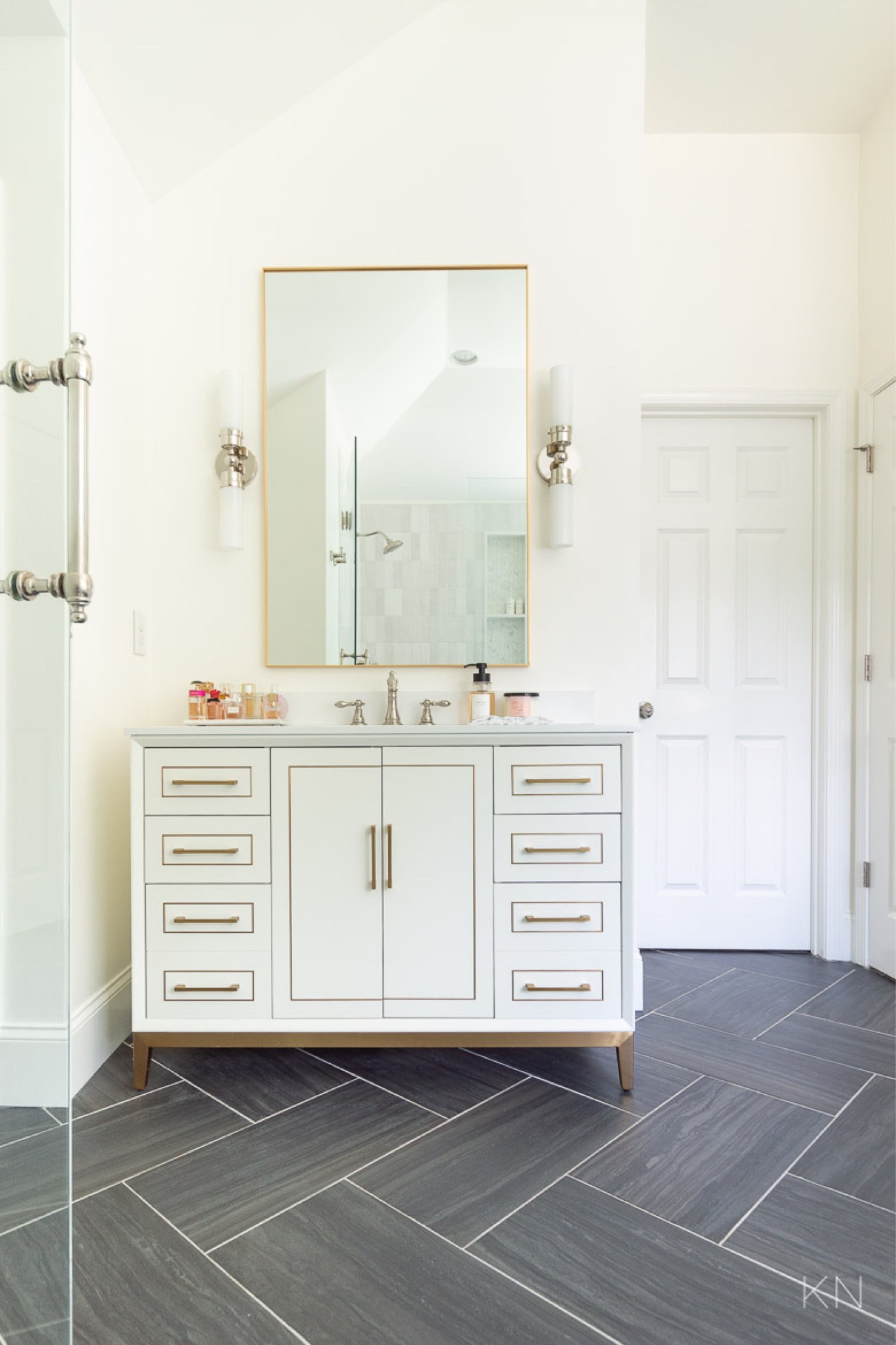 The white vanities in our primary bathroom have so many great features, including amazing drawer space and interior outlets. This vanity is available in multiple color and counter options. (Ours are the white with white granite too, but Carrera marble is also available.) And…they ship for free! Home decor bathroom decor white vanity bathroom vanity top styling sconce lighting gold mirror black floor tile

#LTKHome #LTKStyleTip #LTKSaleAlert