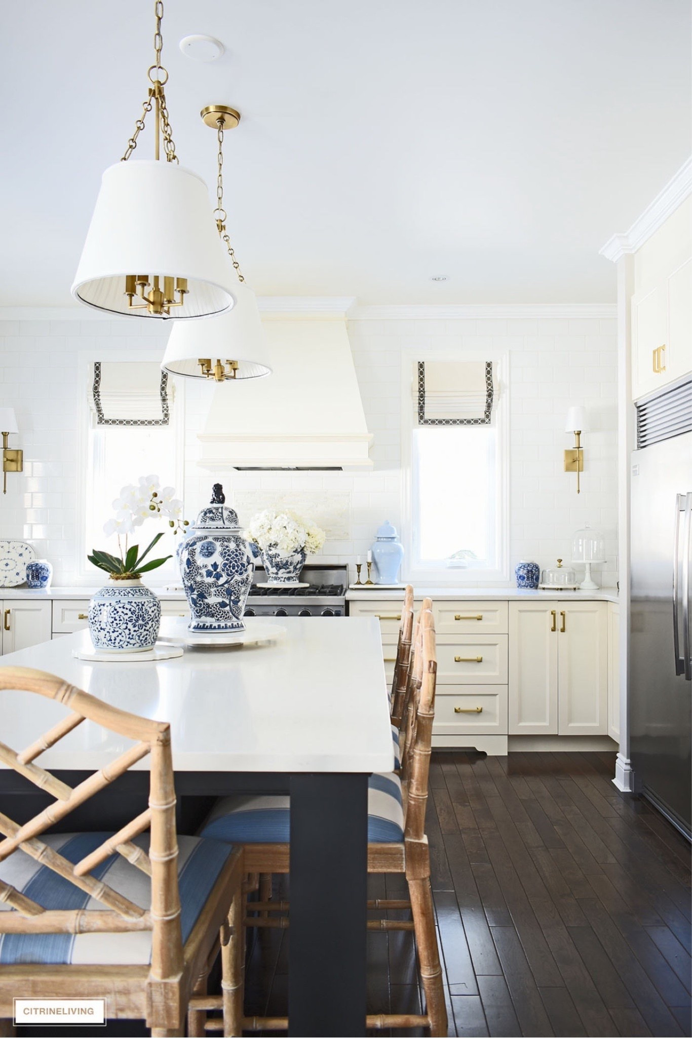 Spring kitchen decor! Blue and white ginger jars, hydrangeas, orchids, brass wall sconces, pendant light, barstool

#LTKHome #LTKSeasonal
