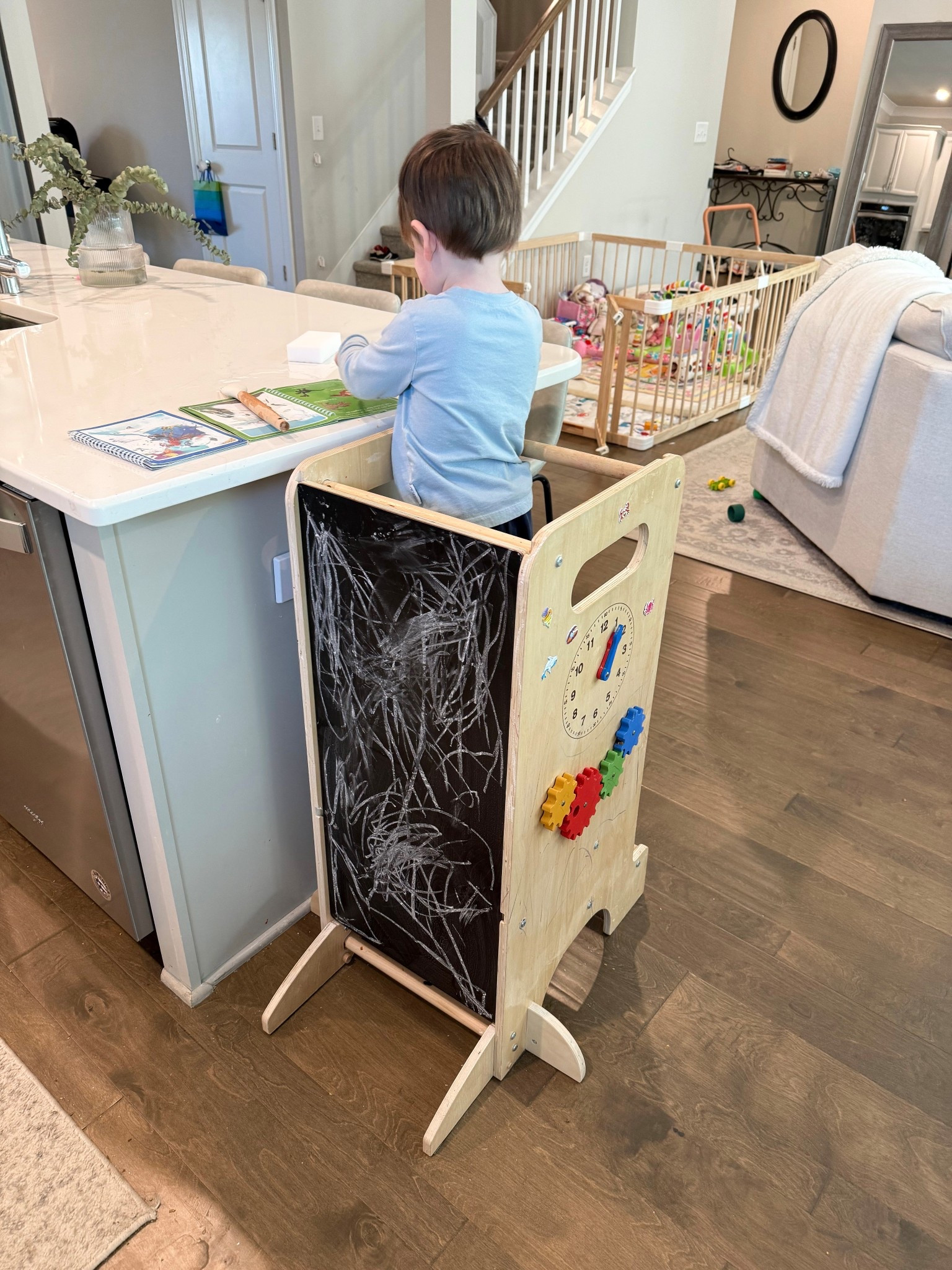 We use this toddler tower every day! It has a chalk board on the back and toys on each side 

