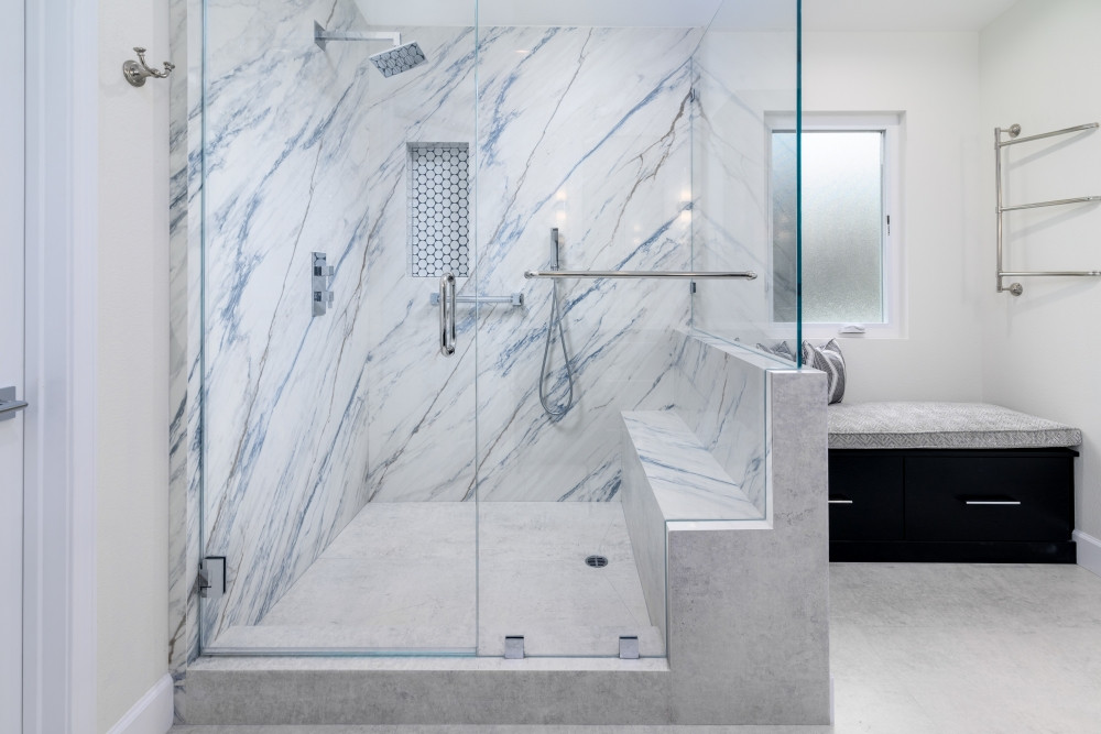 A shower designed to feel like a spa retreat—every single day. We designed and remodeled this luxurious bathroom to feature Dekton slabs with stunning veining, paired with a built-in bench, handheld sprayer, and dual grab bars for beauty and accessibility. The custom niche adds contrast and convenience, while the glass enclosure keeps the space open and light-filled. From comfort to cleanability, this shower was built to elevate your daily routine.

Want a bathroom that feels like a five-star escape? We’re here to design it.

#BathroomRemodel #LuxuryShower #SpaInspiredDesign #AccessibleBathroom #PorcelainSlabs #ZeroThresholdShower #BathroomInspo #LTKHome #PinterestBathroom #DesignBuildFirm #ShowerNicheGoals #CustomShowerDesign #MarbleLookTile #InteriorDesignInspo #ModernBathroom #FunctionalLuxury 

 #LTKHome