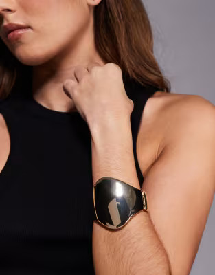 ASOS DESIGN bangle bracelet with large abstract detail in gold tone | ASOS (Global)