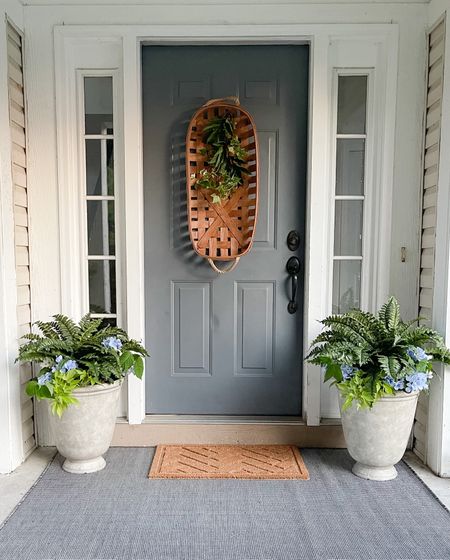Ready to welcome guests with our classic Summer front porch. Ferns in planters and layering outdoor rugs softens up the space. 

#LTKunder50 #LTKSeasonal #LTKhome
