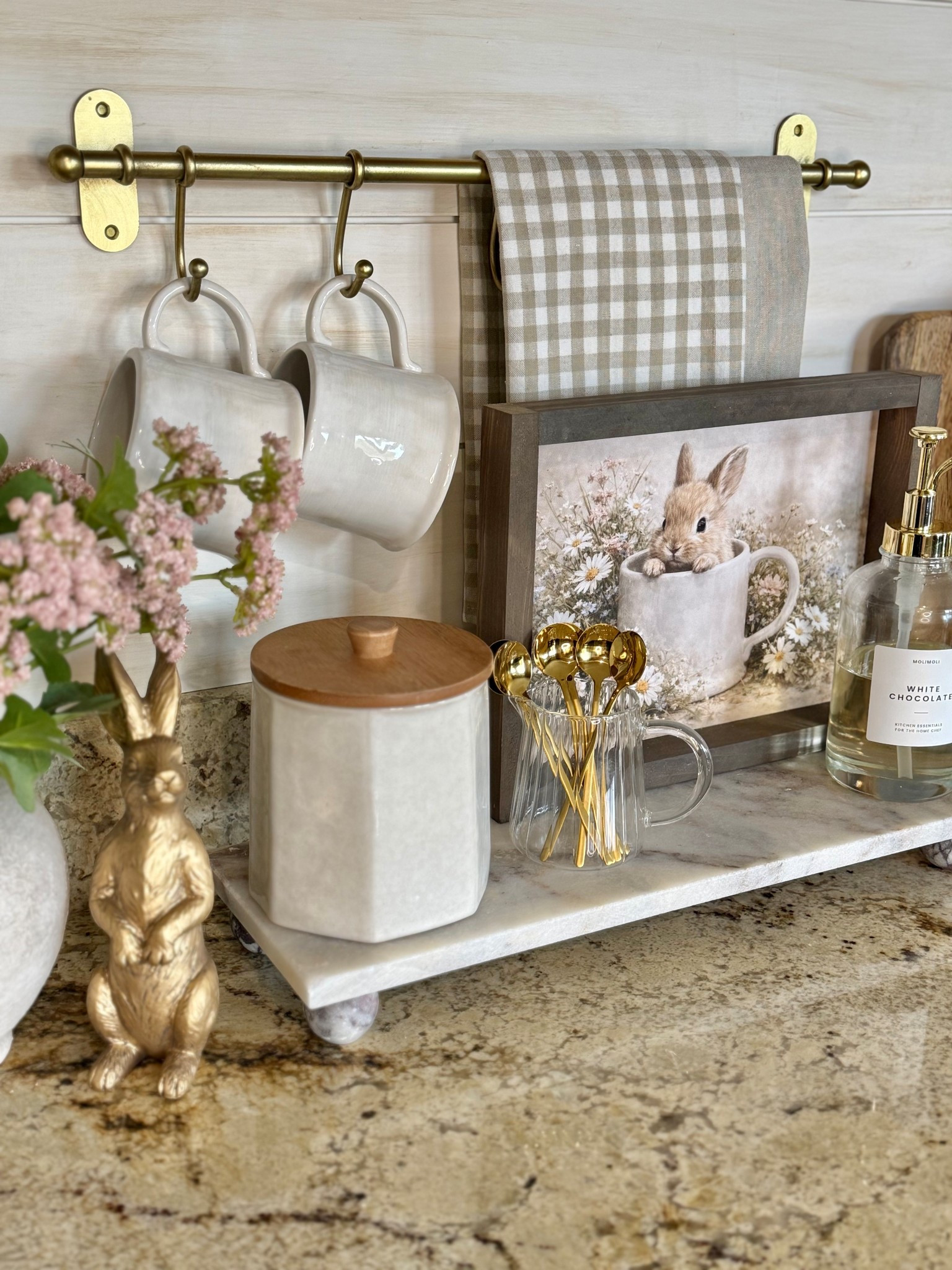 Spring | Easter Coffee Bar 

Follow @farmtotablecreations on Instagram for more home styling ideas and daily deals.

Follow along as I style the cutest piece of spring artwork from my sweet friend Brittany @currentlychic. The Bunny’s Morning Brew is shown here in the 9x12 size with the Briarsmoke stained frame, and it adds the most charming seasonal touch to this little coffee bar moment.

I paired it with neutral mugs (that perfectly match the one in the artwork), softly layered tea towels, a set of gold spoons for a warm, collected feel, and a bottle of syrup to make those morning cups feel a little extra special. It’s such a simple way to bring a little Easter charm into the kitchen while keeping everything light, cozy, and neutral enough to enjoy all season long.

Use code FARMTOTABLE to save 15% off artwork.
Four stems in vase.

#coffeebar #springdecor #easterdecor #springrefresh #springcoffeebar #kitchen #counterdecor #springcoffeebar #eastercoffeebar



#LTKSaleAlert #LTKSeasonal #LTKHome