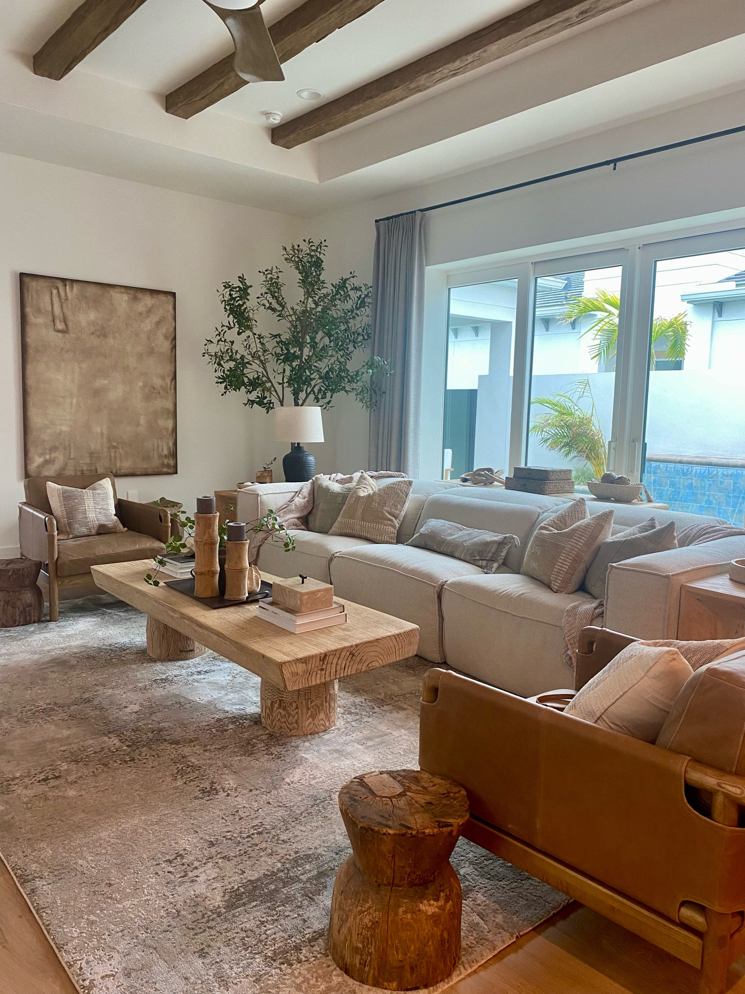 Love the Arhaus motion sofa and Four Hands leather chairs, coffee table, wall art and rug pull this room together.  This sofa is SO comfortable.

#LTKHome
