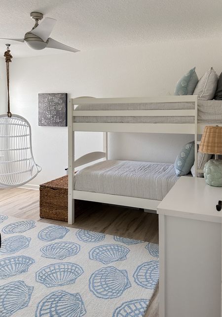Coastal bunk room 🐚 Bunk beds are super solid and on sale, this hanging chair is also on sale. The wicker chest at the end of the bed holds games and extra blankets and we also love this dresser. 

#LTKKids #LTKHome #LTKSaleAlert