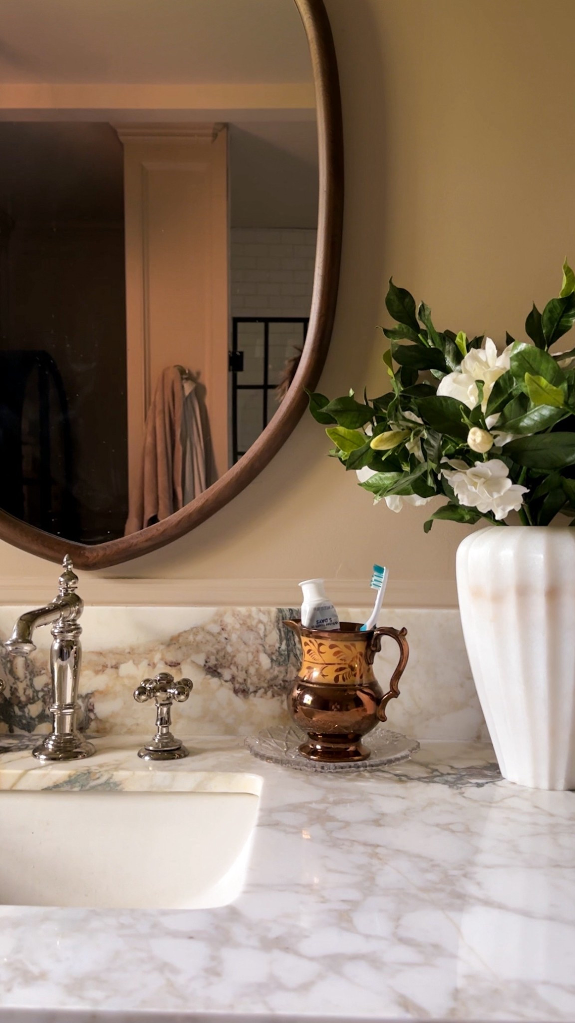 A reminder to Mae the every day things pretty with some simple styling like a vintage copper English pitcher for your toothbrush, a pretty marble vase and some spring florals. #springdecor #vintagedecor #bathroomstyling



#LTKHome