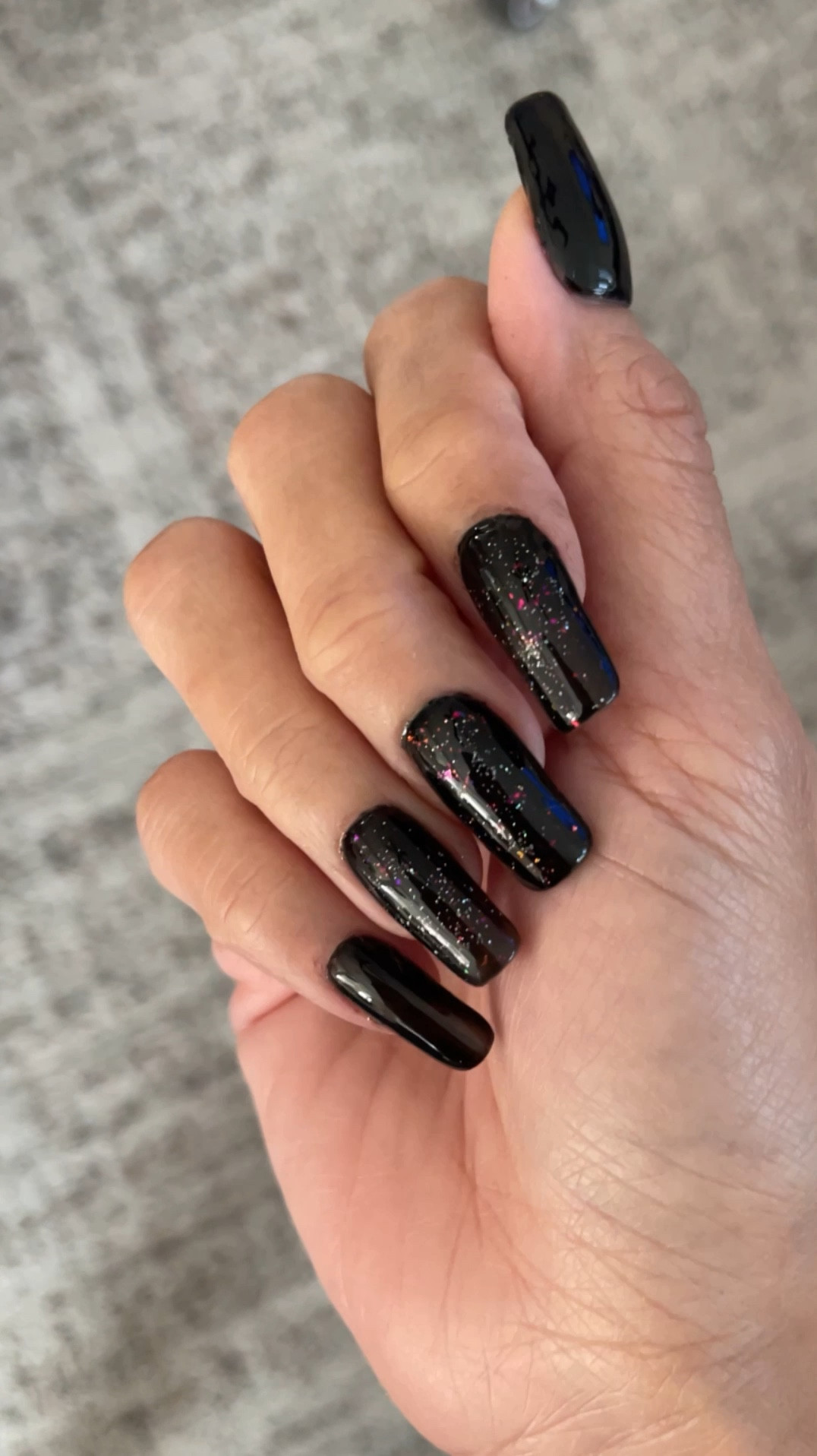 A simple way to care for my right now is with a change of gel nail polish. This is a 
Gel X manicure done at home. 💅🖤✨ I have linked the jet black gel nail polish. That only takes one coat to provide the coverage that you see here. I have also length the glitter top coat that I have over a couple accent nails. 

In dark times, a galaxy themed manicure helps me feel better. 🌌 

If you haven’t done gel X, nails, before, they are like a hybrid of acrylic and gel nail polish. The results is a nail that you can apply like a press on, cure with a UV lamp, and it is durable yet flexible. These nails are less damaging than acrylics, they can be soaked off for easy removal. 

#LTKBeauty #LTKVideo #LTKFindsUnder50