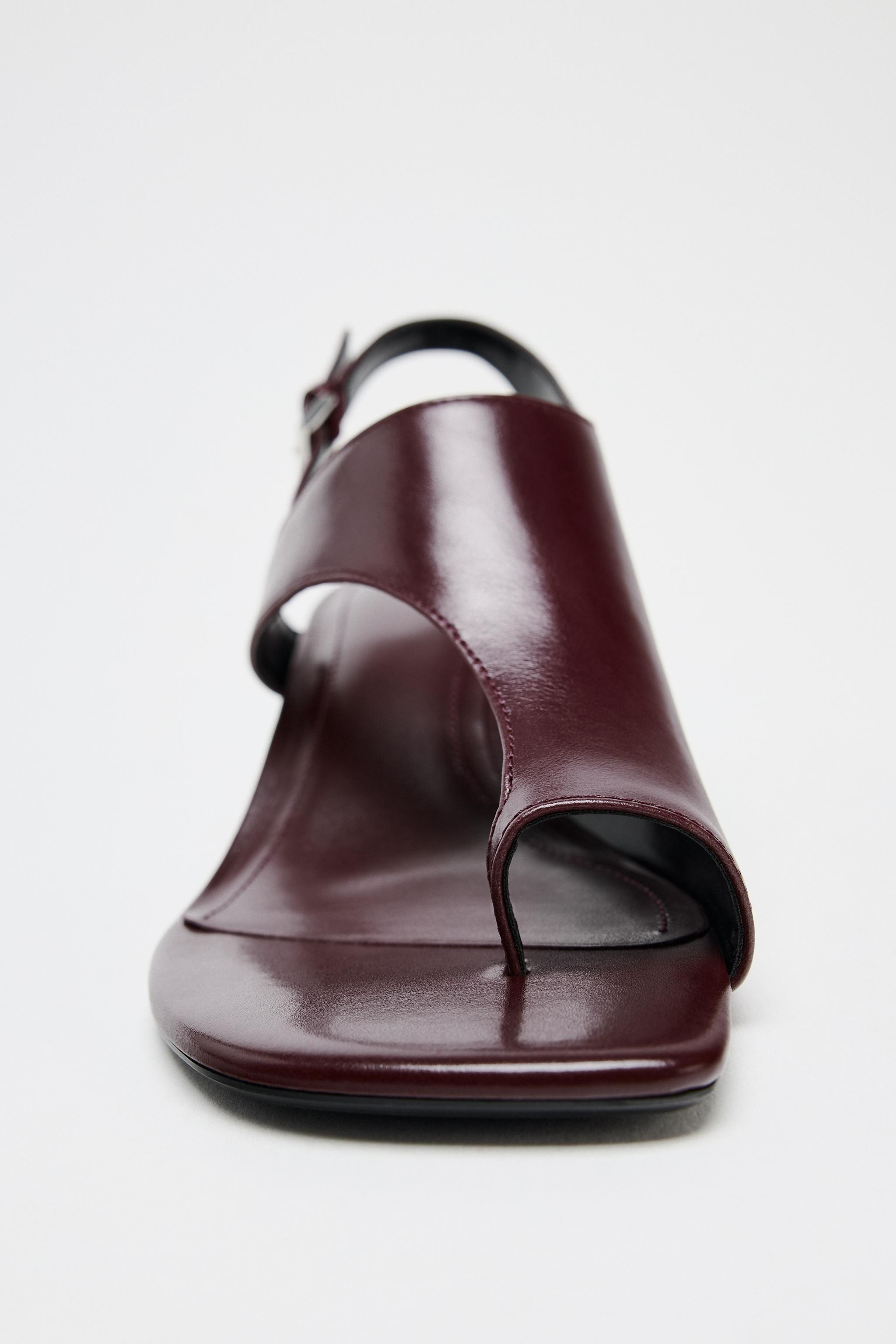 Leather heeled sandals. Wide asymmetrical strap at the front with toe separator. Thin mid-height ... | Zara US