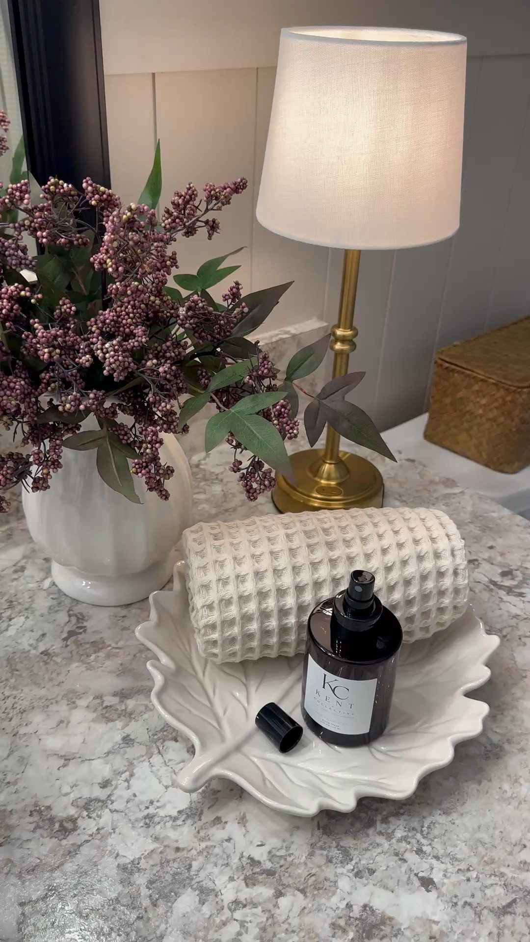 Cozy Bathroom Vignette 🤎

I created this cozy little vignette here in my bathroom space, and I love how it all came together! A warm little lamp, beautiful berry stems, a textured towel, and the prettiest leaf tray add those soft, cozy touches that make the space feel extra inviting.

I also added the Kent Collective Room Spray, and I’m so impressed! It smells SO good, and I especially love that it’s made with clean, nontoxic ingredients. It’s thoughtfully crafted with premium plant-based ingredients, a 100% biodegradable, water-based formula, and leaves behind no heavy residue. The bottle is such a generous size too! Just a few sprays leave the room smelling fresh, clean, and cozy. 🤍#LTKFinds #BathroomDecor #BathroomInspo #CozyHome #FallHome #FallDecor #HomeDecor #HomeInspo #KentCollective #RoomSpray #CleanIngredients #NonToxicHome #PlantBased #CleanHome #HomeFragrance #CozyDecor #SeasonalDecor #HomeStyling

#LTKHome #LTKHome #LTKSaleAlert #LTKSeasonal