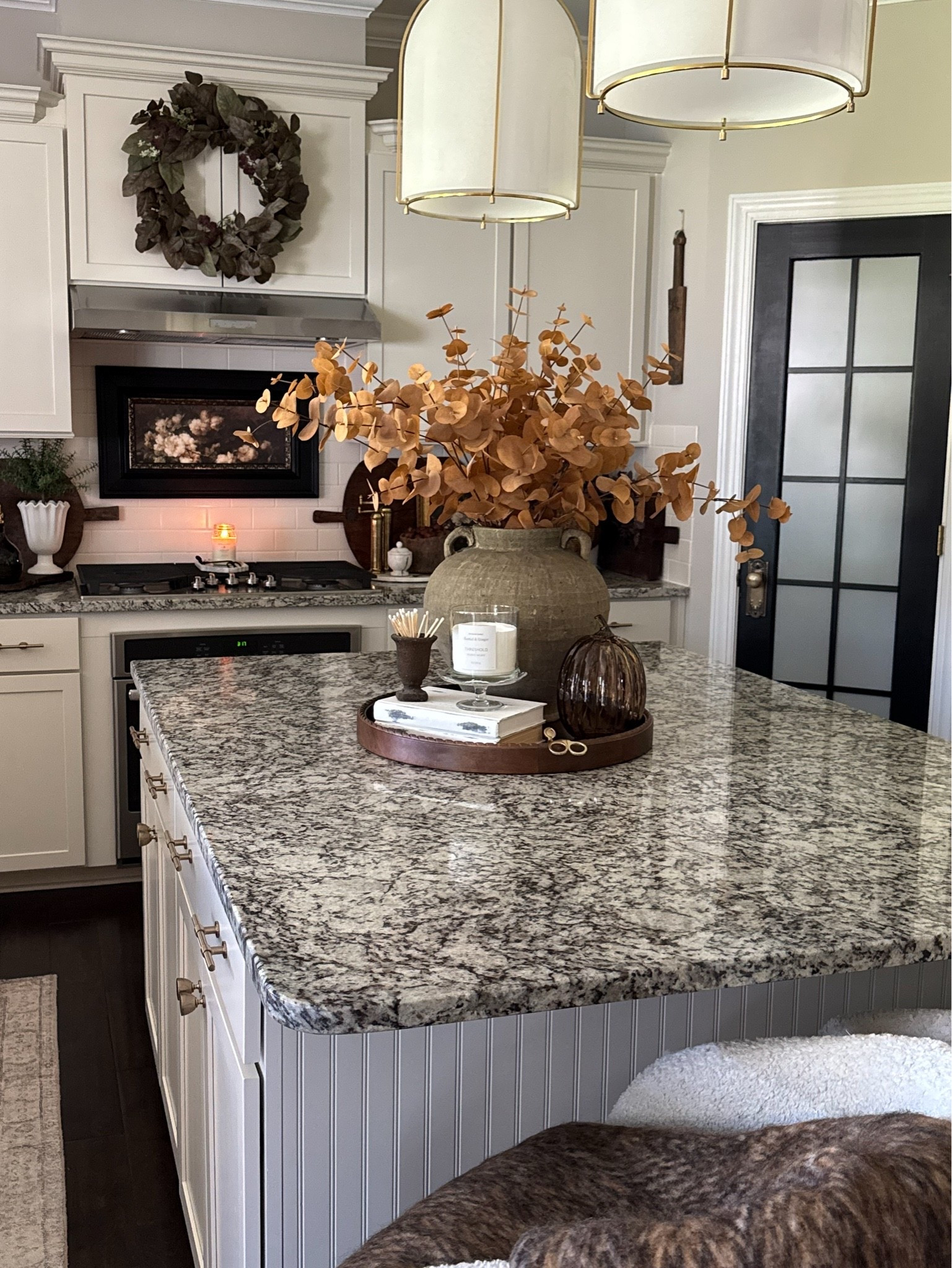 Fall Kitchen!!
Love the warmth of this styling. Perfect on your island, coffee table, or dinner table. I was able to source a few mini urns and vintage crystal compotes.

Wood tray, large brown vase, toasted eucalyptus, amber glass pumpkin, mini urn, white matches, styling books, vintage crystal compotes, gold wick trimmer, candle, island pendants, burgundy wreath, antique brass doorknob

#LTKHome #LTKSeasonal #LTKstorytime