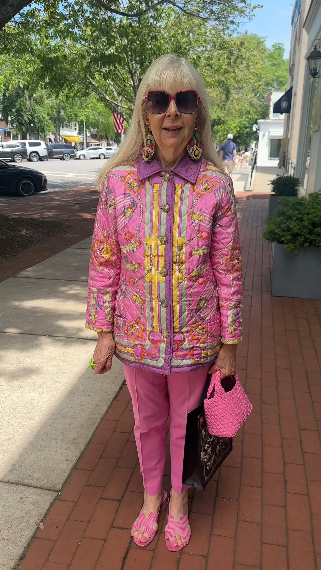 Not everyone can pull off head-to-toe pink, but this stylish Hamptons woman embraces it with confidence. From the quilted jacket to the woven handbag, every detail works together to create a look that is bold, playful, and personal.
