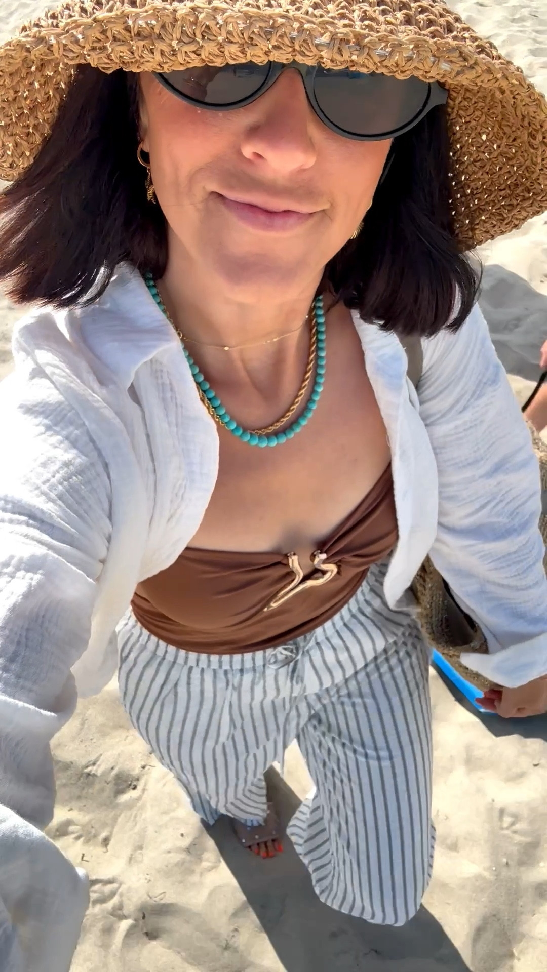 Beach OOTD! 🤎☀️🌊 

Obsessed over this new swimsuit has the prettiest gold detail! And I’m vvvv into all things chocolate brown right now 

• swimsuit — wearing size medium 
• Striped linen Pants - small (fully lined!) 
• White gauze button down - size small (part of a set)

#LTKSwim #LTKootd #LTKTravel