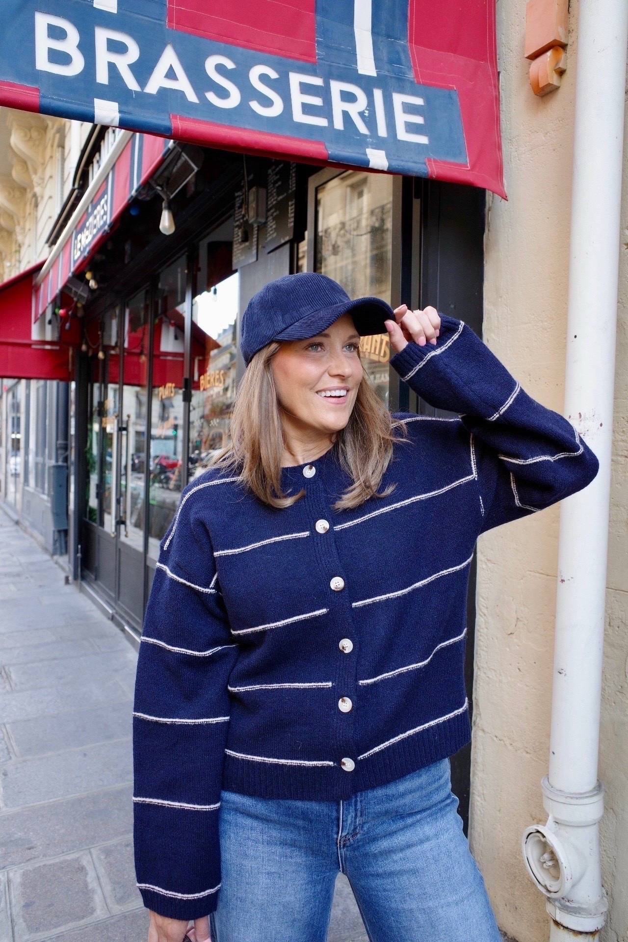 Navy stripes always feel classic, and this cardigan is such an easy layer for fall. I styled it with wide leg jeans, suede flats, and a simple cap for a relaxed Parisian vibe. The structured bag adds the perfect finishing touch. 

#LTKMidsize #LTKSeasonal #LTKOver40