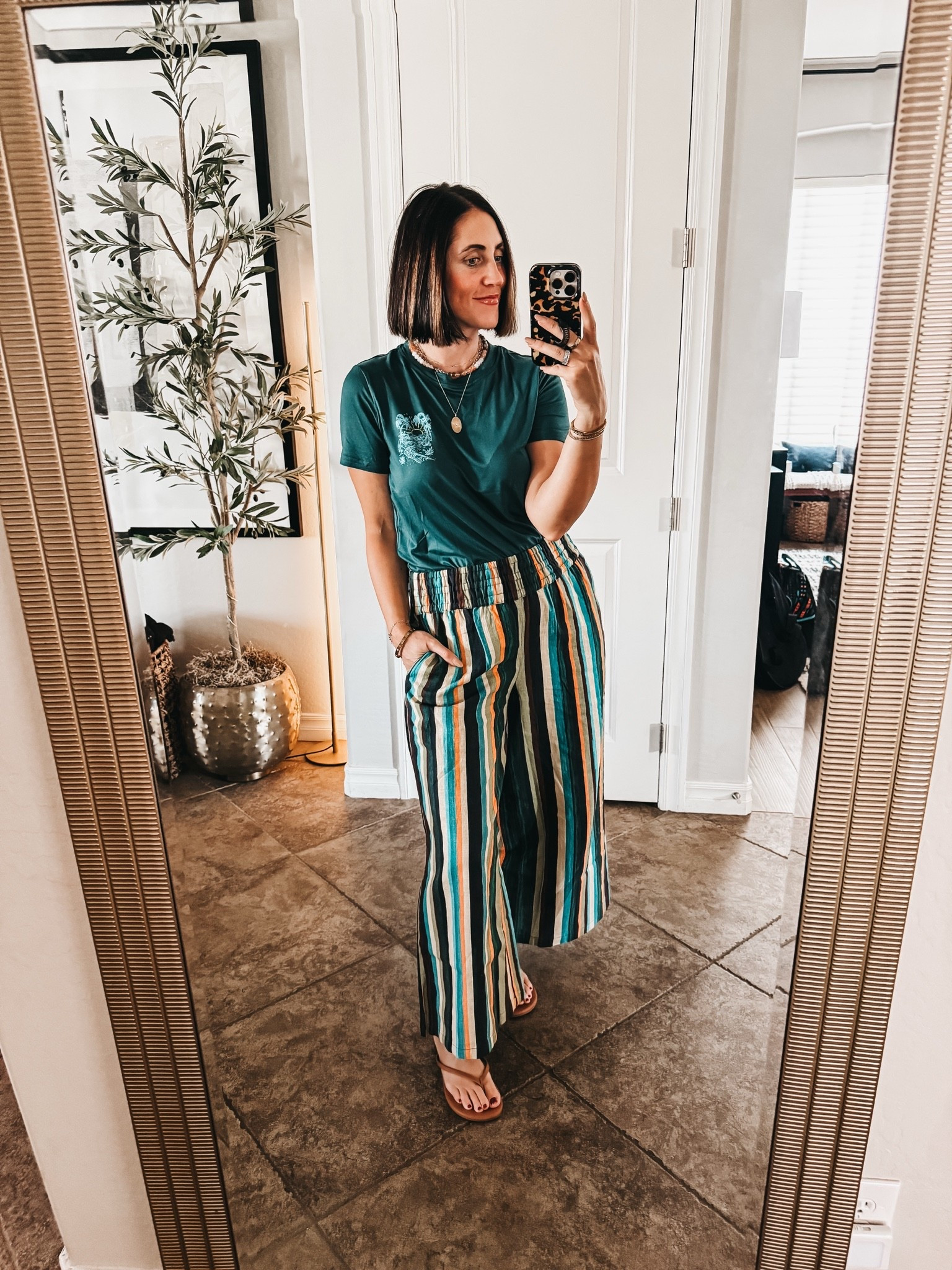 Graphic tee + striped wide leg pants = my kind of easy outfit formula 🌴 Threw this on for a casual day out and it’s giving casual relaxed vibes without trying too hard. The stripes do all the work here!

Tee – size small
Striped wide leg pants – size small
Sandals – size 8
Necklaces – linked!

Comfy, colorful, and no ironing required. Perfect for those “I have 5 minutes to get dressed” mornings 😅

#ltkfindsunder50 #ltkstyletip #ltkunder100