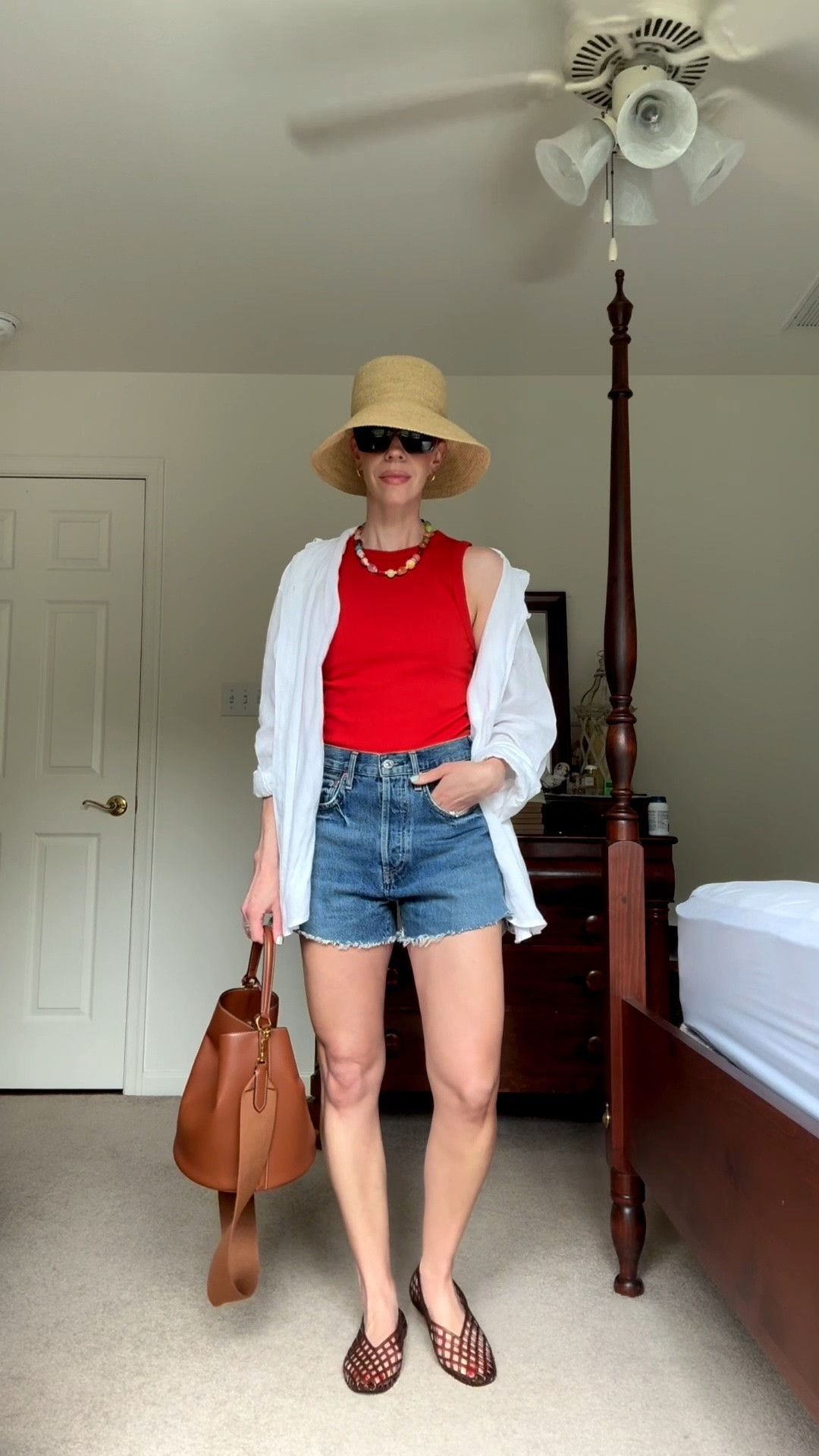 Casual summer outfit with @Janessa Leone straw bucket hat, red tank, beaded necklace, cutoff denim shorts, jelly shoes

#LTKSeasonal #LTKOver40 #LTKgrwm