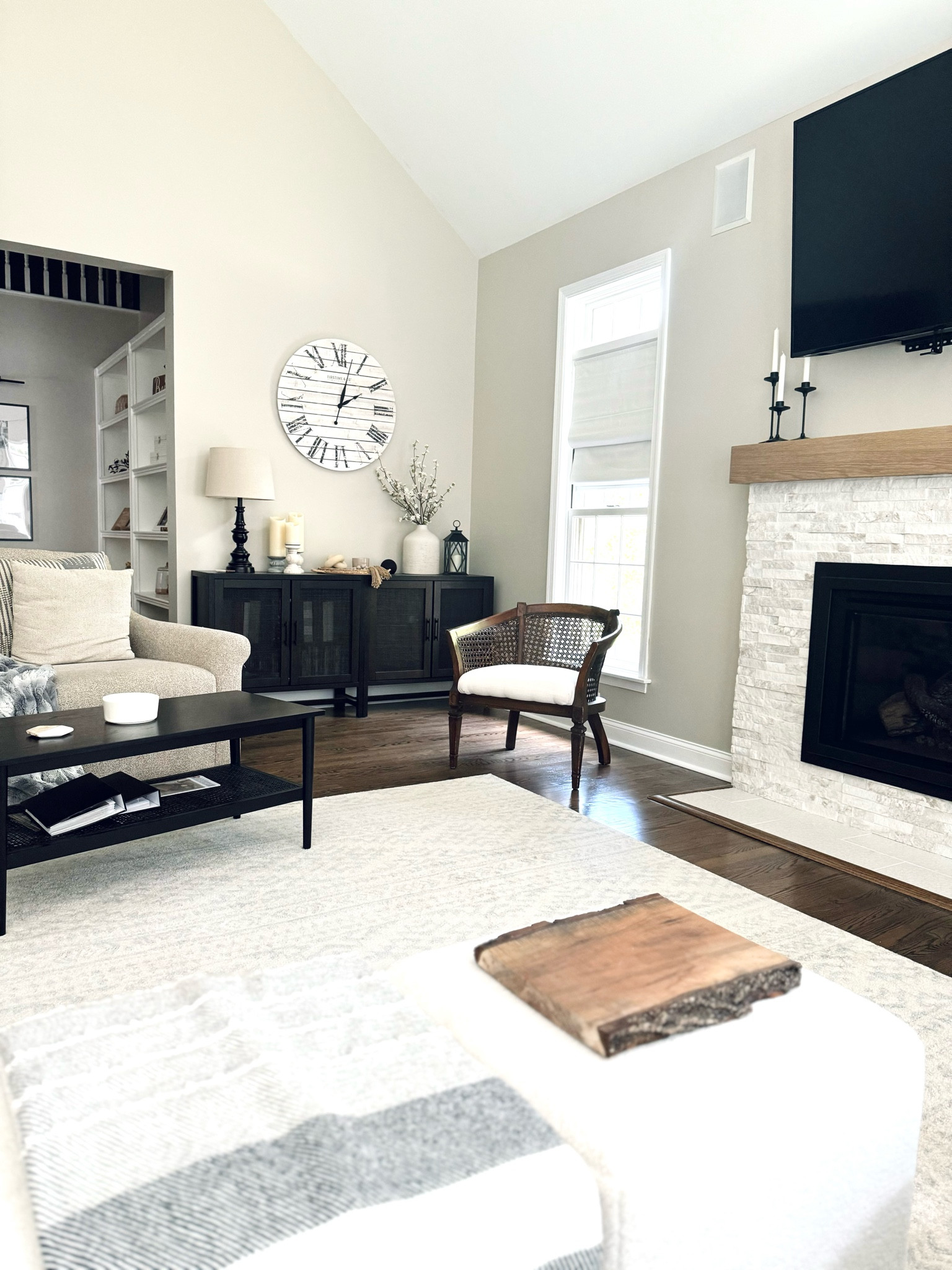 Neutral living room with accented cane furniture 🖤

This winter we replaced the living room carpet with oak hardwood flooring. The large accent rug is perfect for warming the space. We also remodeled the brick fireplace by tiling overtop. We removed the dated three sided mantle, and replaced with an oak floating mantle. 
I accented with white Sherpa ottomans, a cane entertainment stand, cane coffee table, and cane chair. 


#LTKHome