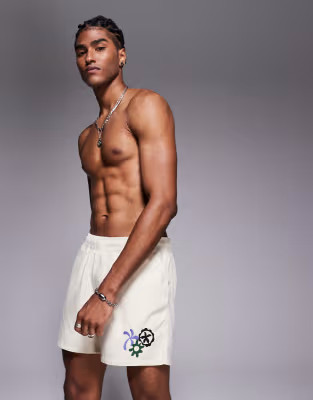 ASOS DESIGN swim shorts in short length with embroidery in neutral | ASOS (Global)
