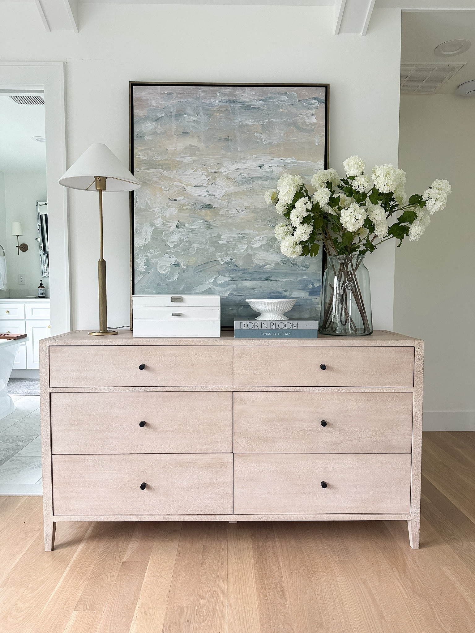 Bedroom, dresser, bedroom furniture, Rylee, dresser from pottery, barn, modern coastal, traditional home, dresser styling coastal artwork, floral snowball flowers, Amazon home jewelry, organizing bedroom design

#LTKStyleTip #LTKHome #LTKSaleAlert