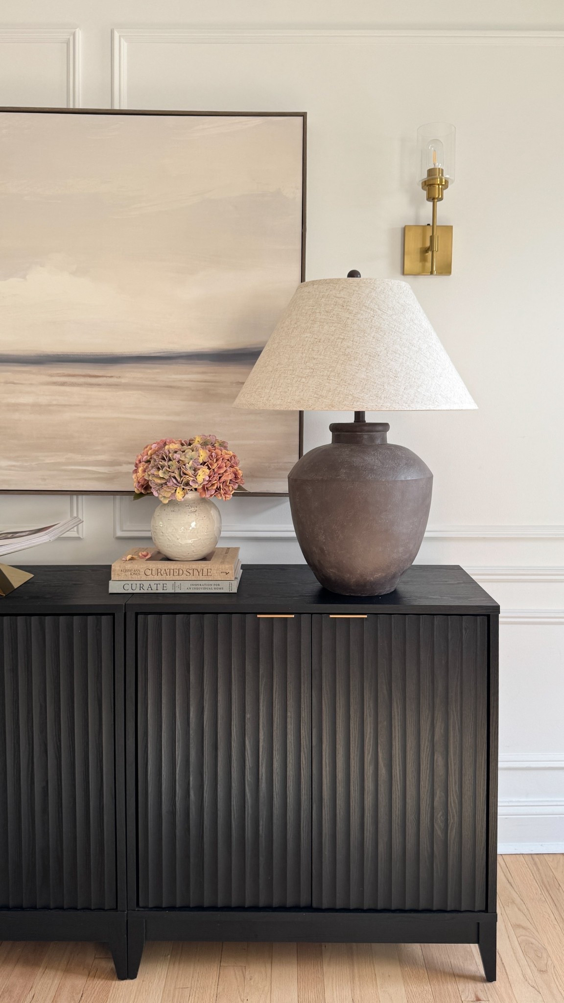 Can we take a second for this console setup? 🤎 Found the most beautiful oversized 40x60 Target art find (under $170!) that seriously looks so much more expensive than it is. I paired it with my favorite fluted black console, a moody stone lamp, stacked books, and muted hydrangeas for that cozy-elevated vibe.

It’s simple but feels pulled together—and such a good reminder that you don’t have to spend designer $$$ to get that look. Everything’s linked here for you if you’re refreshing your entryway or living room. ✨

#TargetHome #NeutralHome #ConsoleStyling #ModernOrganic #LTKHome

#LTKHome #LTKSaleAlert #LTKSeasonal