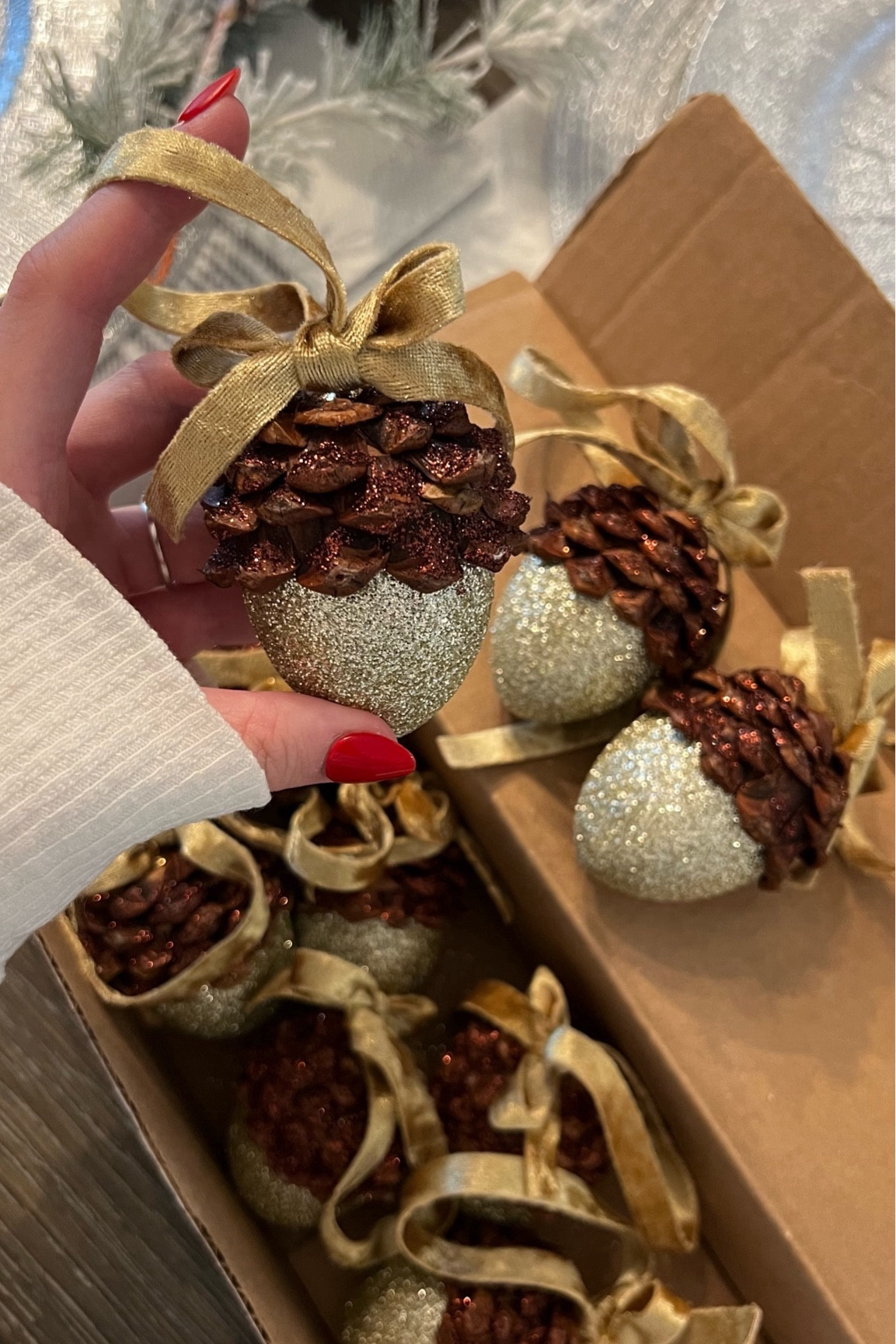 
Linked most of what I used to make these! Then you’ll need small scissors and pine cones, either from outside or you can get them from craft stores like Joann Fabrics - two 3qt bags or so! 
*Plus paint brush and brown paint if you get the white wooden eggs*

I followed the video below for the most part, but I painted my wooden eggs brown at the top (1 inch), started with the champagne glitter on the bottom half of egg, then used a glue gun for the pine cone pieces to make sure they stuck well. 

The ribbon bows were a little difficult, but I tied around a water bottle to get the right loop hanging sizes. Message me if you have any questions!

Acorn ornaments DIY Video Link:
https://www.smilemercantile.com/blogs/tutorials/beautiful-acorn-ornaments-with-pine-cones-and-glitter-diy-christmas-craft


#LTKHoliday #LTKSeasonal #LTKGiftGuide