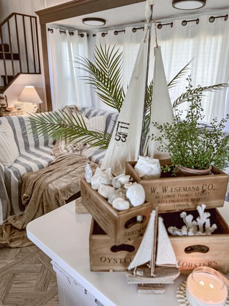 Cozy summer coastal inspired living room decor. This is our beach house— our destination trailer that we have on a permanent lot in Ocean Isle Beach, NC. 🤍🐚🐠🦀🦞☀️

#LTKFindsUnder100 #LTKSeasonal #LTKHome