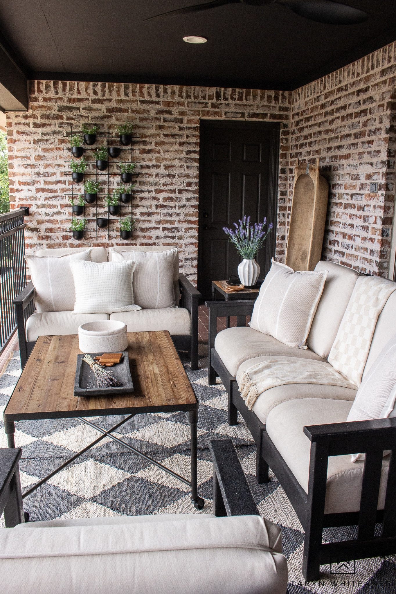 Modern transitional outdoor balcony decor, mixing black, wood and neutrals with lots of greenery and vintage pieces. Lots of seasonal items on sale! 

#LTKSeasonal #LTKsalealert #LTKhome