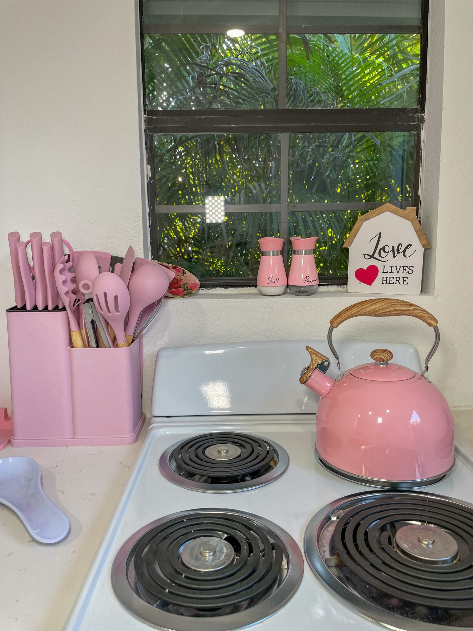 Matching pink kitchen essentials, complete with a cute kettle and spice shakers.