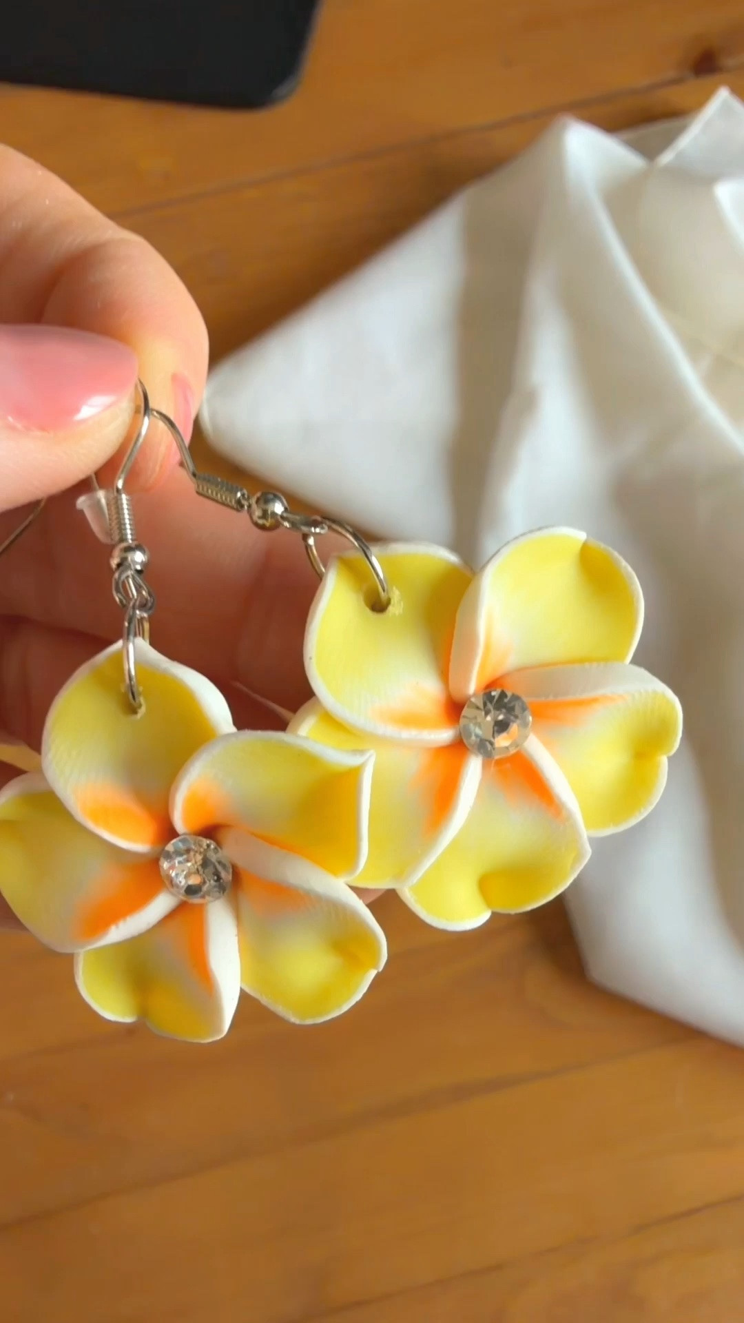 Obsessed with these gorgeous yellow plumeria floral drop earrings! The perfect tropical accessory to elevate your spring and summer outfit inspiration! Featuring vibrant yellow and orange clay petals with a sparkling rhinestone center on silver fishhook wires—these lightweight statement earrings add the perfect touch of tropical paradise, vacation style, and resortwear vibes.

Whether you’re packing for a beach vacation, island getaway, tropical trip, cruise outfit, or looking for cute summer jewelry, handmade floral earrings, and bride-to-be accessories for a tropical bachelorette party, these floral dangles are a must-have!

plumeria earrings, frangipani jewelry, yellow flower earrings, tropical jewelry, summer accessories, beach vacation style, resortwear accessories, floral dangle earrings, handmade clay earrings, rhinestone flower earrings, island style, summer outfit ideas, tropical aesthetic, cruise outfit details, spring trend jewelry, cute aesthetic accessories.

#LTKunder50 #LTKtravel #LTKstyletip #LTKshoecrush #summerstyle #vacationoutfit #tropicalvibes #floralearrings #plumeria #resortwear 

 #LTKSeasonal #LTKTravel