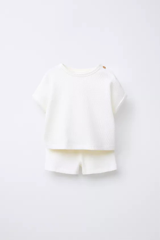 Two-piece set. T-shirt with round neck and short cuffed sleeves. Button closure at shoulder. Shor... | Zara US