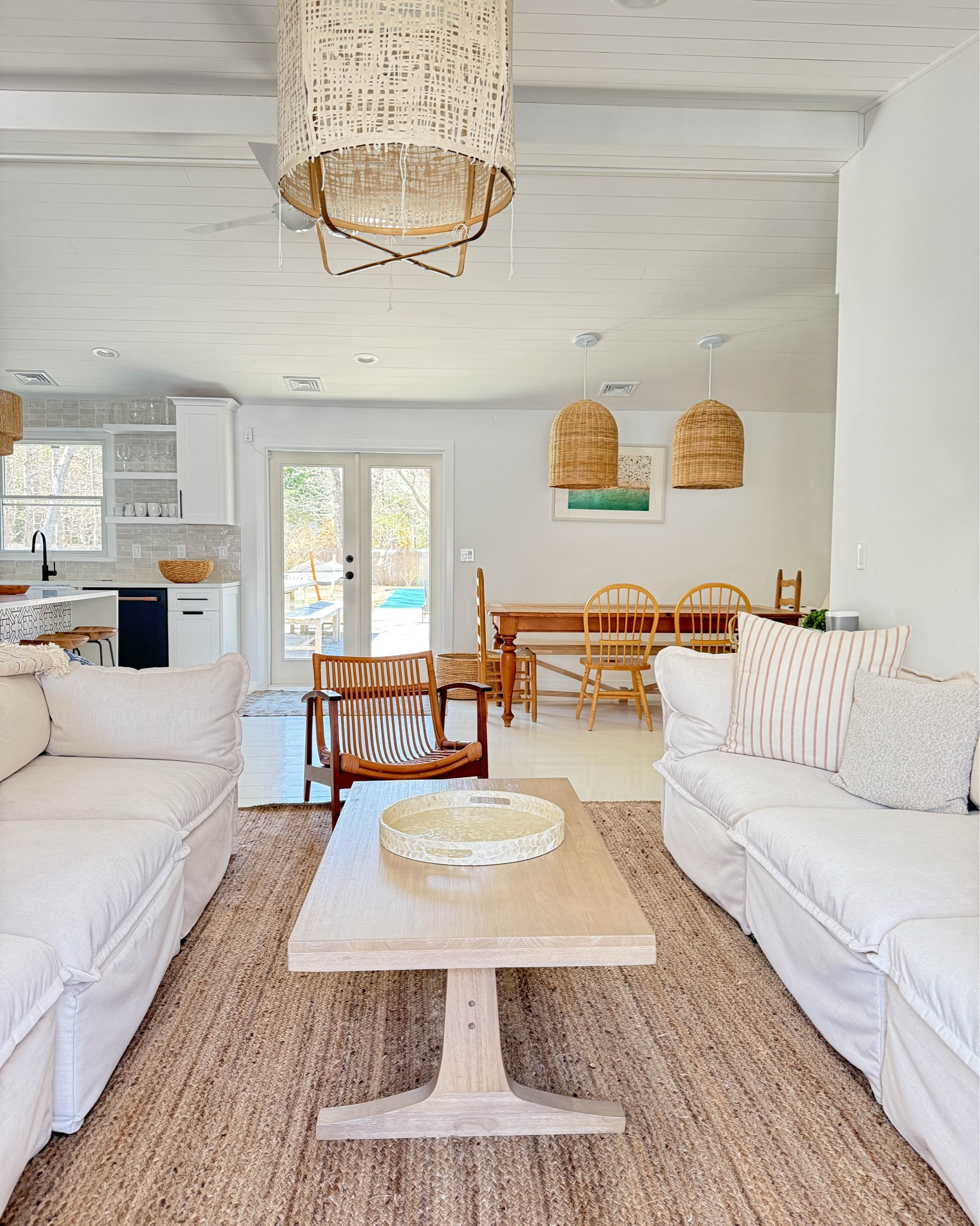 beach house style — in our hamptons ranch, we have a neutral palette with a lot of white. Kept it from being too flat by bringing in lots of natural materials like the woven light fixtures, rattan chairs, fiber rug. 

#LTKHome