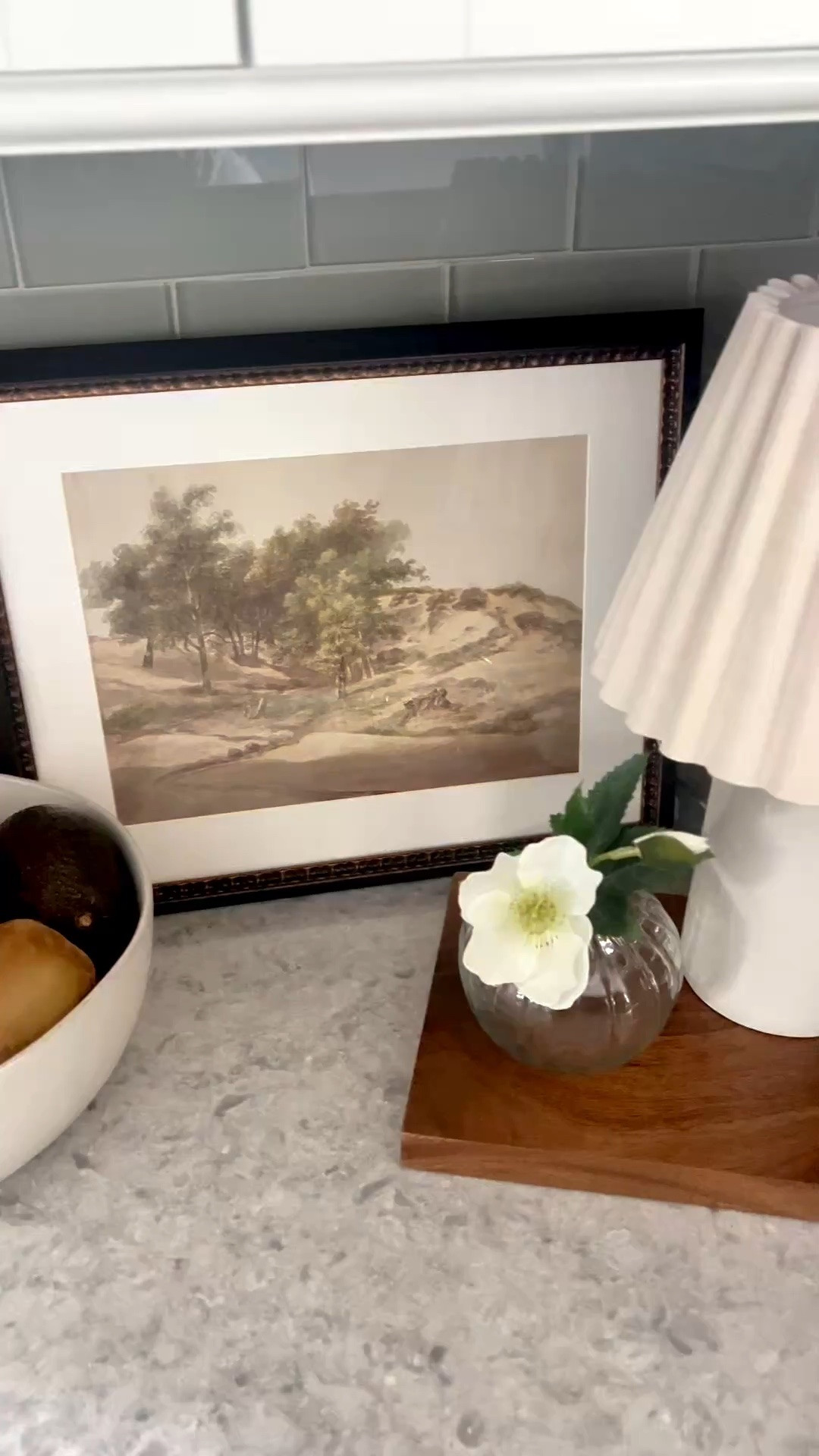 A little kitchen counter refresh with pieces I already had, plus a few new finds. I linked the exact lamp and vase, the same landscape print in a different frame, and similar options for the board and fruit bowl that would give the same warm, collected look.

#LTKHome #LTKSeasonal #LTKOver40