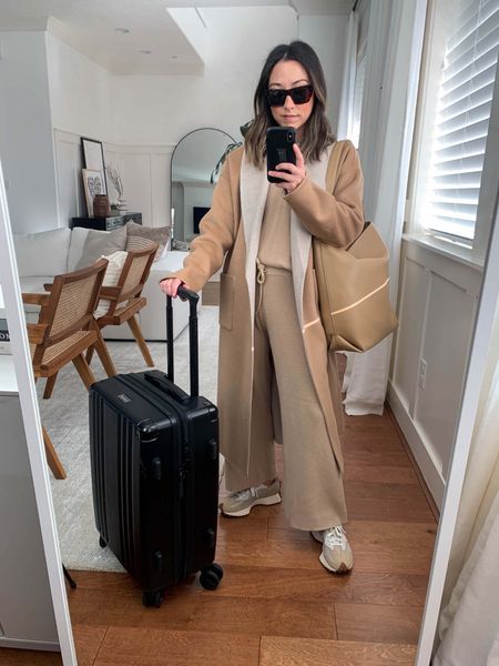 Travel airport outfit ideas. What to wear to travel. Comfy travel outfits. 
Coat is old Eileen Fisher. Linked similar colors. Lounge set is old Rails. 

Coat - Eileen Fisher xxs
Top - Rails xs
Pants - Rails xs
Sneakers - New Balance 4.5 men’s (6 women’s)
Bag - Mango
Sunglasses - Celine
Carry on - Calpak