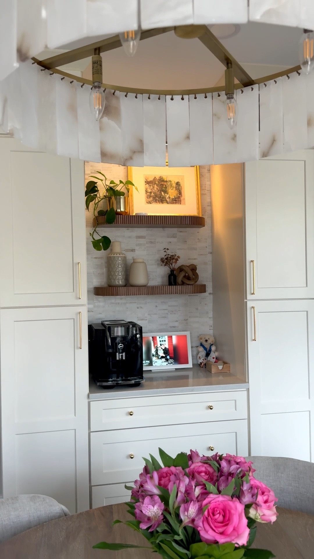 From blank wall to dream coffee bar 🤍☕️

I know it’s been a little quiet over here, but so many of you have been asking for kitchen updates, so here’s a peek at our finished space. Our kitchen renovation is officially complete, even though we had a few appliance hiccups along the way. I also ordered two dining tables that both arrived damaged, so I’m pausing the search for now and just enjoying our home as it is.

This built in coffee bar features cream kitchen cabinets, polished gold hardware, fluted wood shelves, and a marble backsplash for a warm neutral kitchen aesthetic. It’s the perfect mix of functional design and timeless style.

Our Jura E6 coffee machine makes the best at home espresso and coffee, and our Skylight Calendar is a must have for family organization and daily routines in a busy household.

I’m still looking for the perfect kitchen shelf decor and artwork for the frame, but I couldn’t wait to share this coffee bar styling moment with you ✨

coffee bar ideas kitchen coffee bar built in coffee station neutral kitchen design marble backsplash gold hardware kitchen fluted shelves kitchen decor ideas LTK home LTK kitchen LTK finds 👇

#LTKmorningroutine #LTKSaleAlert #LTKHome