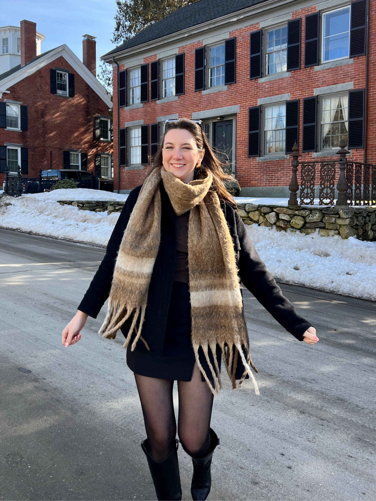 Warm winter outfit with pattered brown scarf, black wool jacket, black skirt, tights, and black boots 

#LTKSeasonal