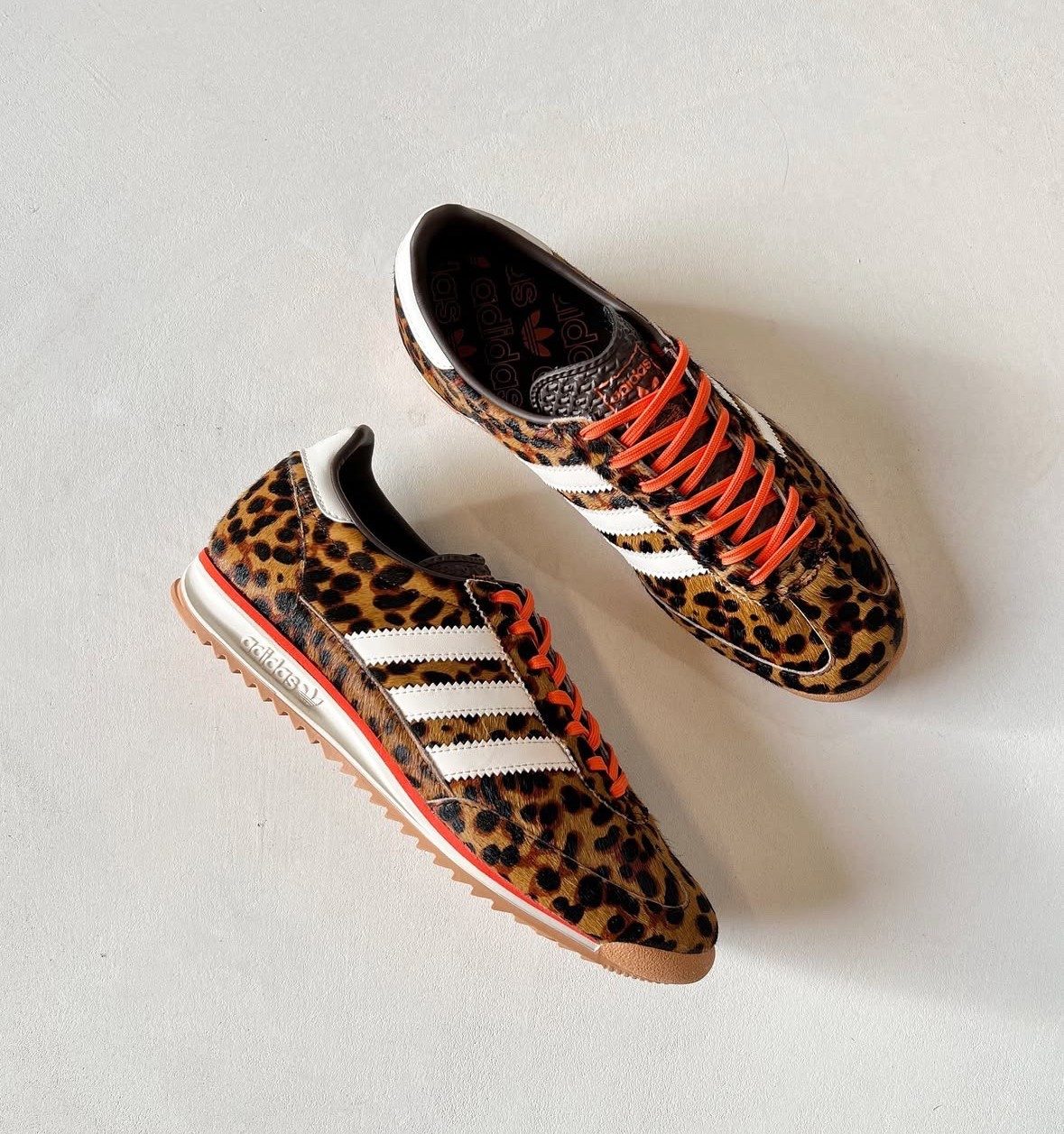 Leopard print trainers with orange laces  