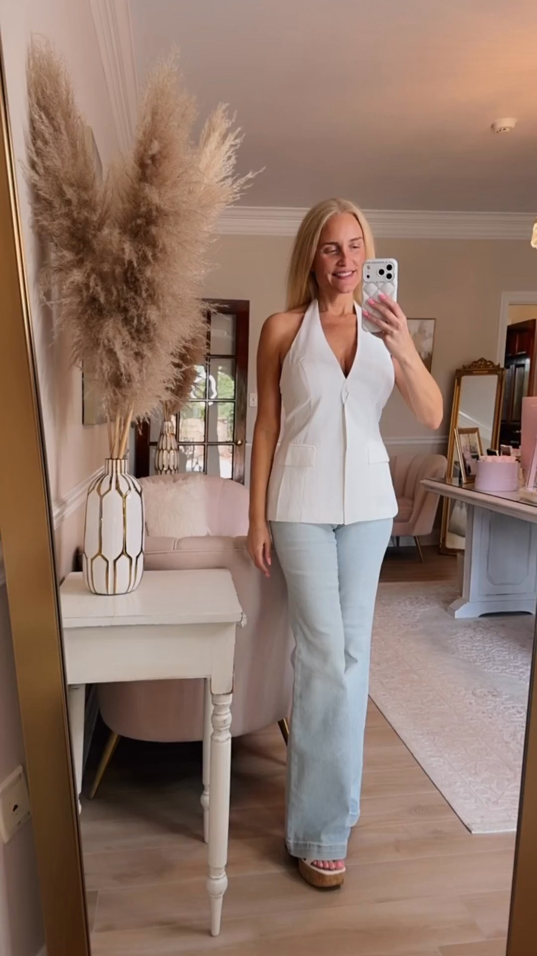 A sleek and sophisticated white vest ￼top paired with my new favorite light wash flare jeans, so cute for summer!

#LTKdayinmylife #LTKgrwm #LTKootd