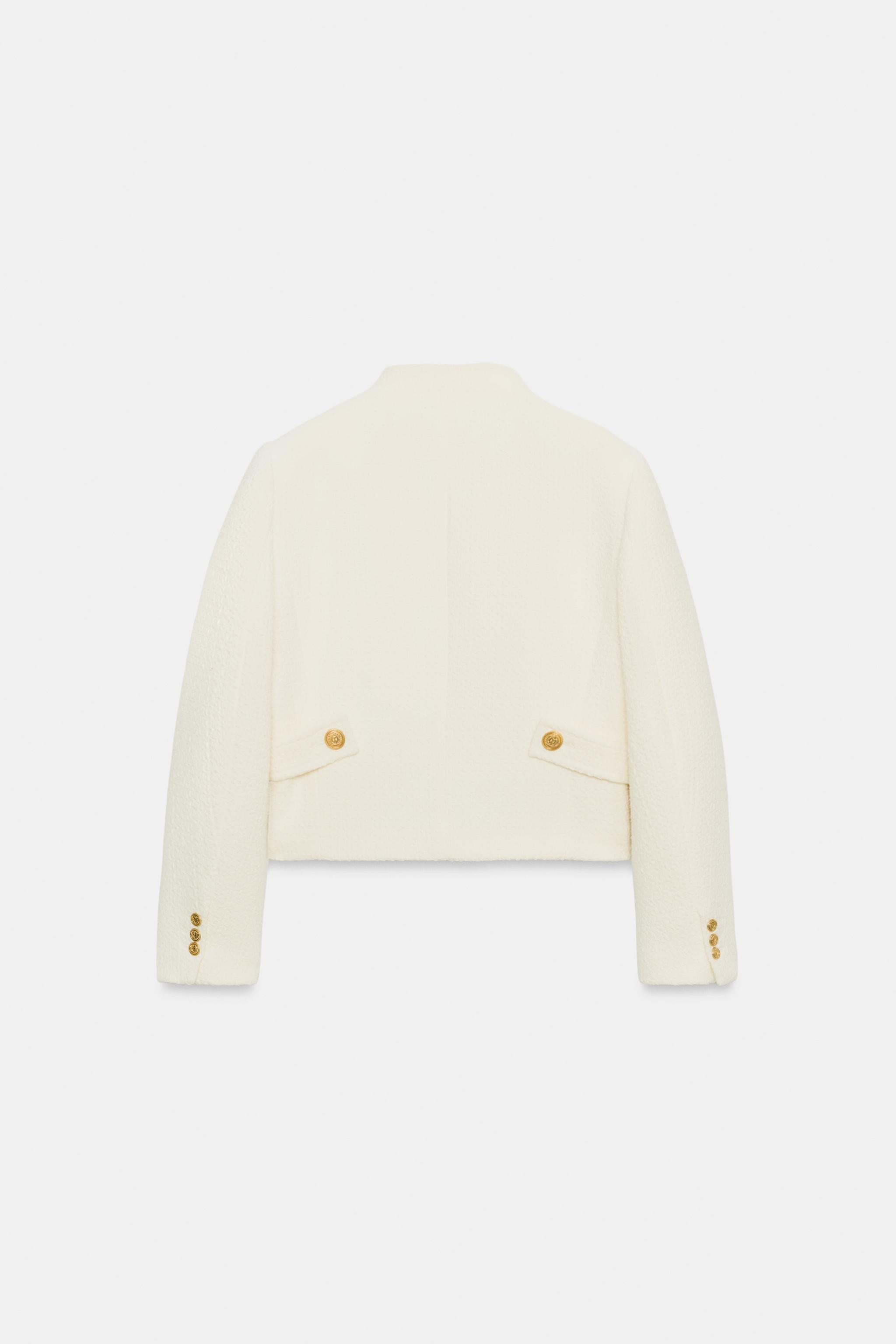 Cropped blazer with a high neck and long sleeves with shoulder pads. Featuring tab details, side ... | Zara UK