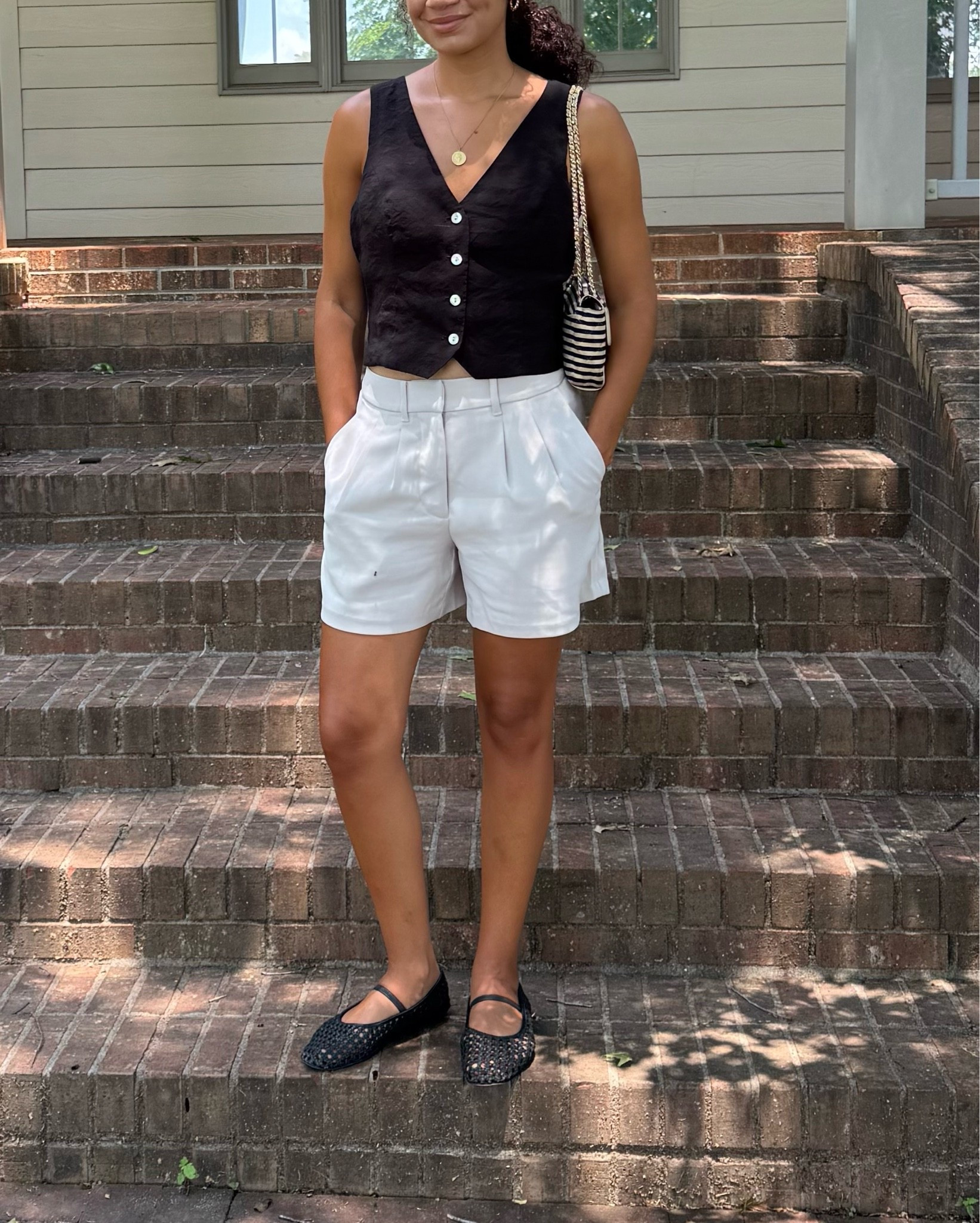 Classy summer outfit: black vest, high waist shorts, flats

#LTKootd