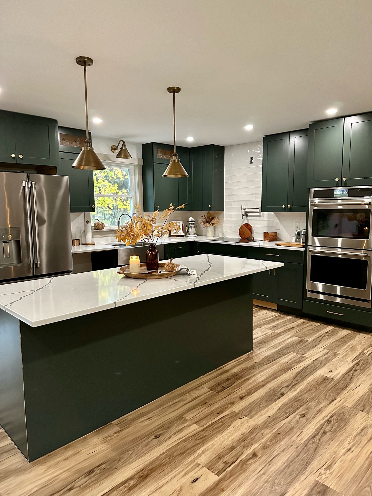 Modern farmhouse kitchen styling with brushed brass pendants and wood accent styling. 

#LTKstyletip #LTKhome