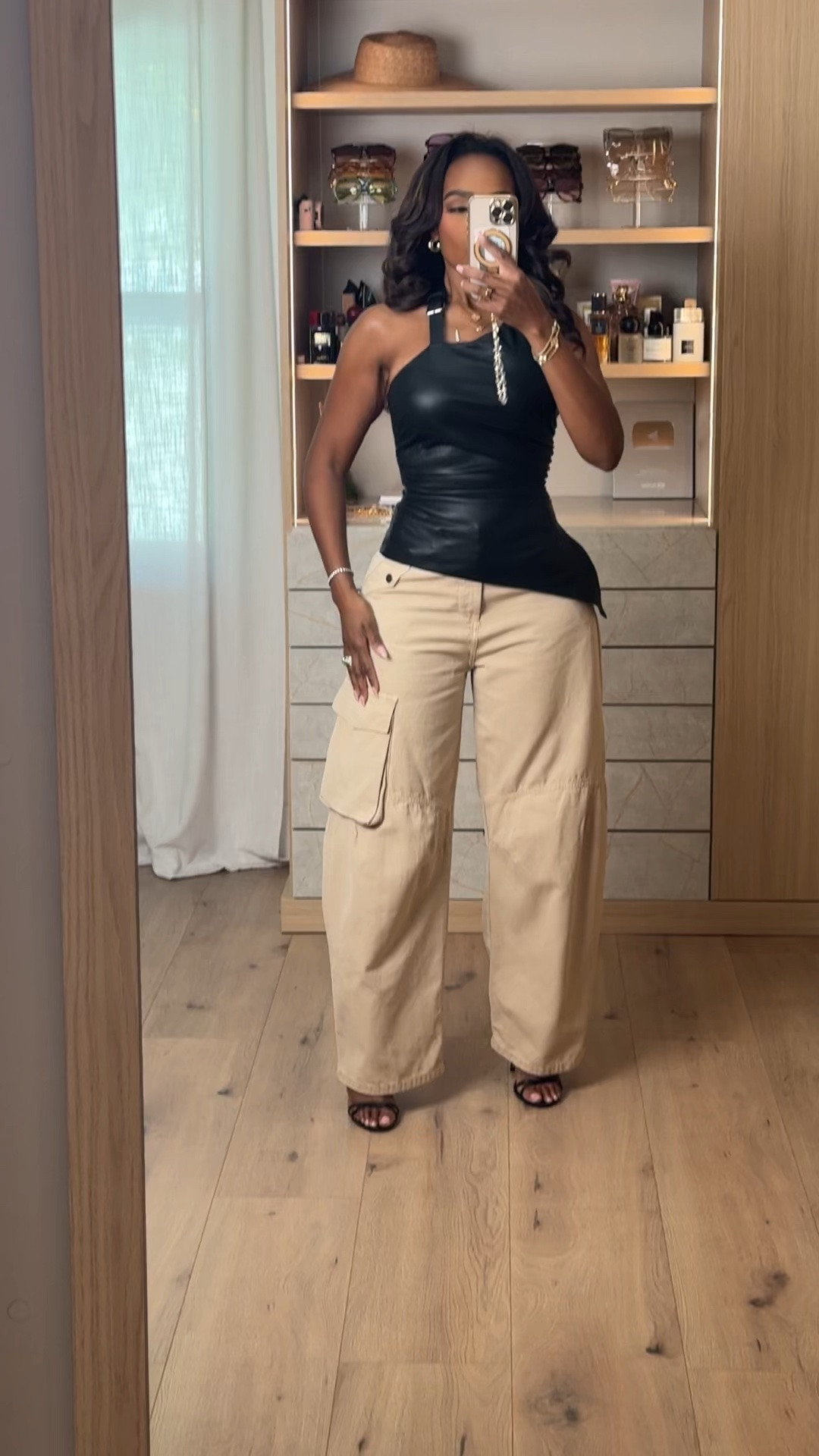 Hi Babes! 🖤✨

I love an outfit that mixes edgy with effortless, and this one does exactly that.

The faux leather top instantly elevates the look, while these relaxed cargo pants keep it cool and comfortable. It's one of those outfits that looks like you spent hours getting ready... but really didn't. 🤍

Fit Details:
• Black faux leather asymmetrical top
• Relaxed wide leg cargo pants
• Black strappy heels
• Gold jewelry
• Chic neutral accessories

Where to wear:
• Dinner with the girls
• Date night
• Concerts
• Rooftop cocktails
• Vacation nights
• Fashion-forward brunch

Everything is linked below!

xx, Kira | IG: KirasFashionFinds

Measurements: 5'3" | Wearing Size XS