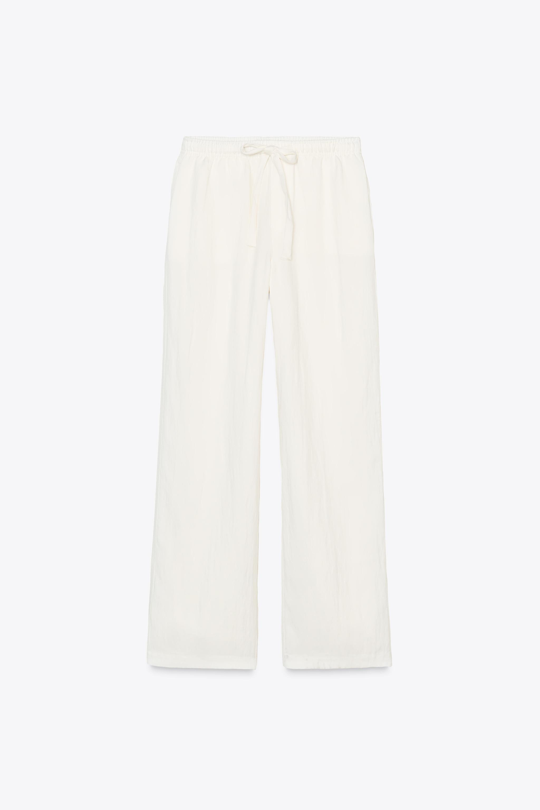 Mid-rise pants with elastic waistband and adjustable drawstring. Side pockets and back patch pock... | Zara US