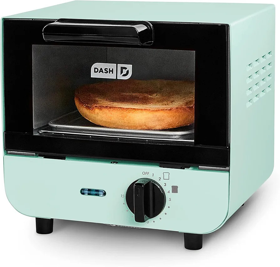 DASH Mini Toaster Oven Cooker for Bread, Bagels, Cookies, Pizza, Paninis & More with Baking Tray, Ra | Amazon (US)
