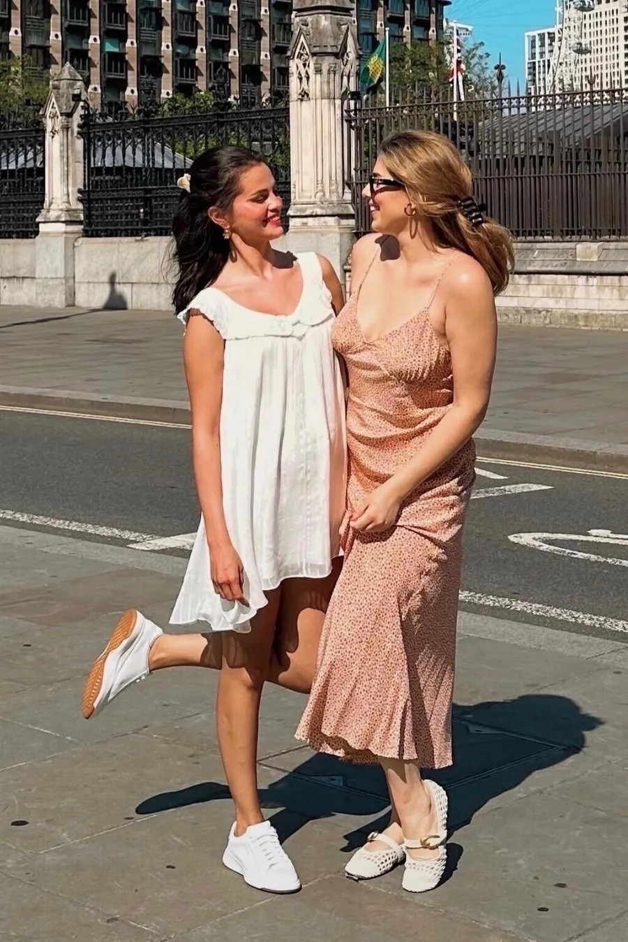 Selena Gomez wearing a cream sundress and sneakers