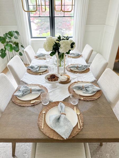 Summer inspired neutral tablescape with a pop of blue block print napkins. Dining room design, gold flatware, world market placemats, white linen table throw

#LTKunder50 #LTKstyletip #LTKhome
