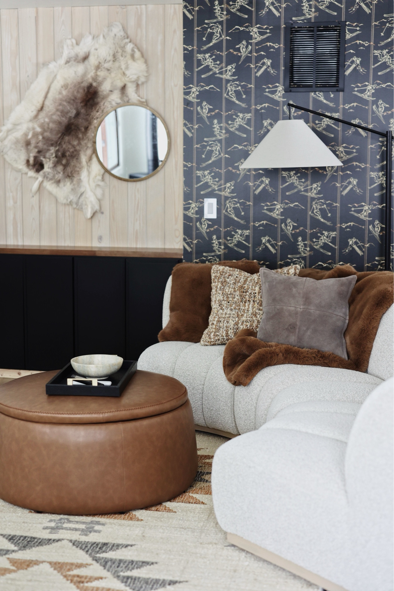 Our favorite cozy little nook at our ski chalet in Breckenridge. This space is so fun— it features lush textiles, a skier wallpaper accent wall, southwestern rug for that mountain house vibe and a leather ottoman coffee table for storage. We are obsessed with the circular boucle sofa. #mountainhouse #skichalet #ltkhome #wallpaper 