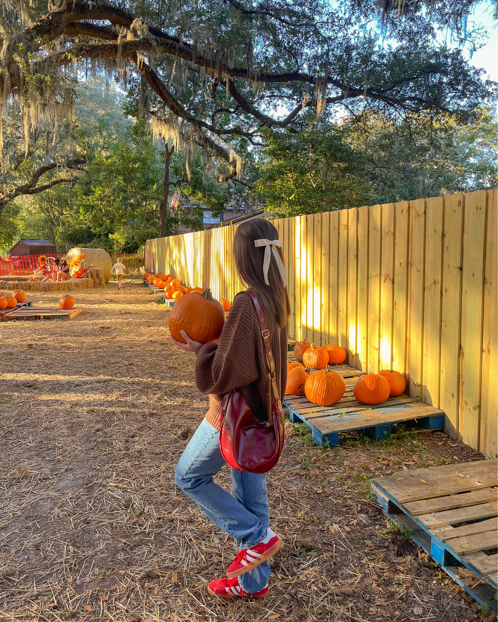 fall outfit, oversized rory gilmore sweater, bow, red purse, red adidas 